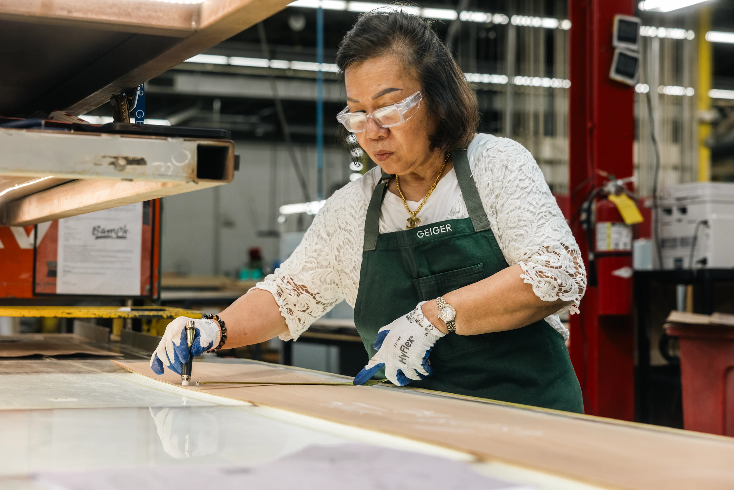Person measuring wood at the Geiger Manufacturing Factory in Atlanta.