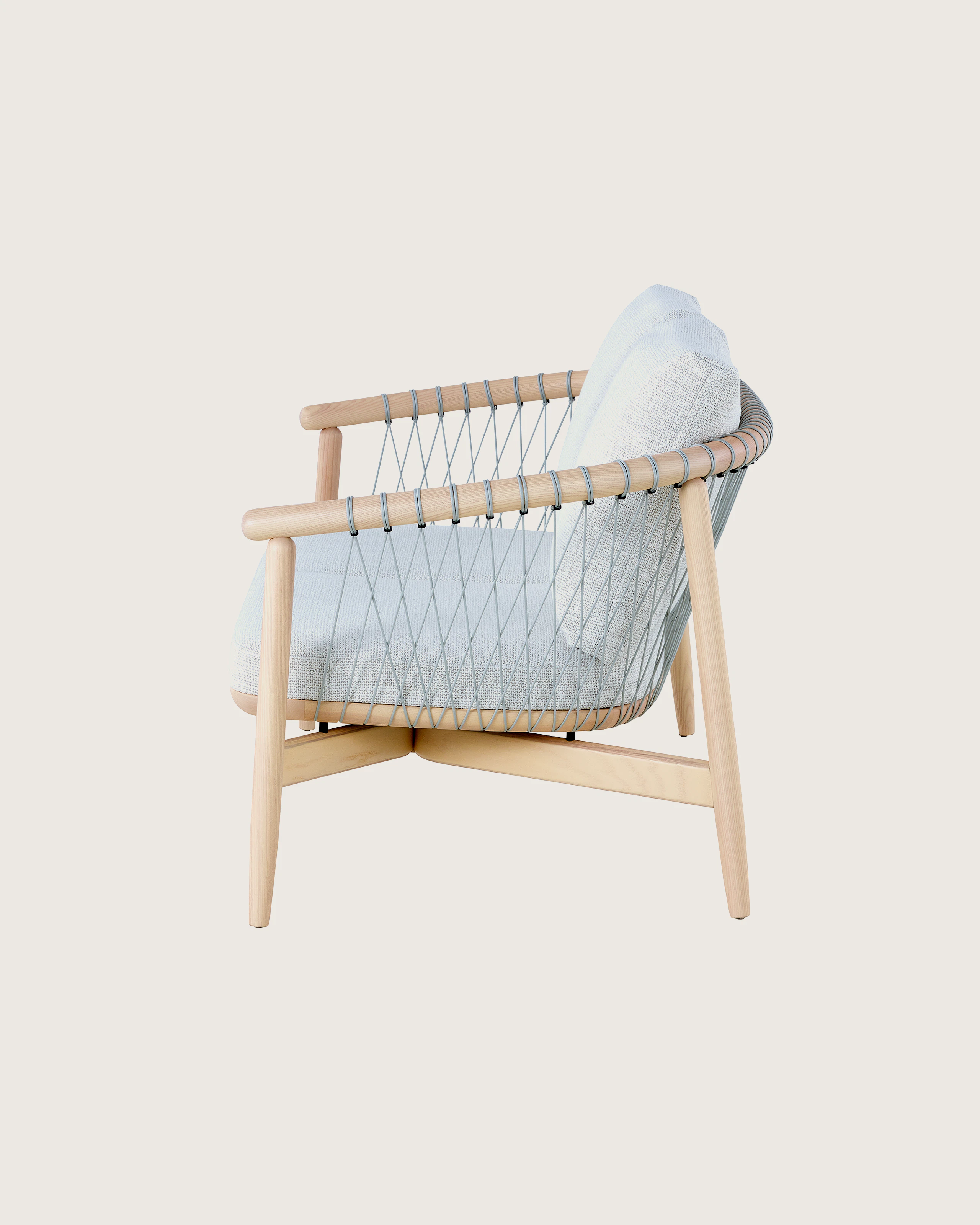A light-colored Crosshatch Settee featuring gray upholstery and a white ash frame. Viewed from the side.
