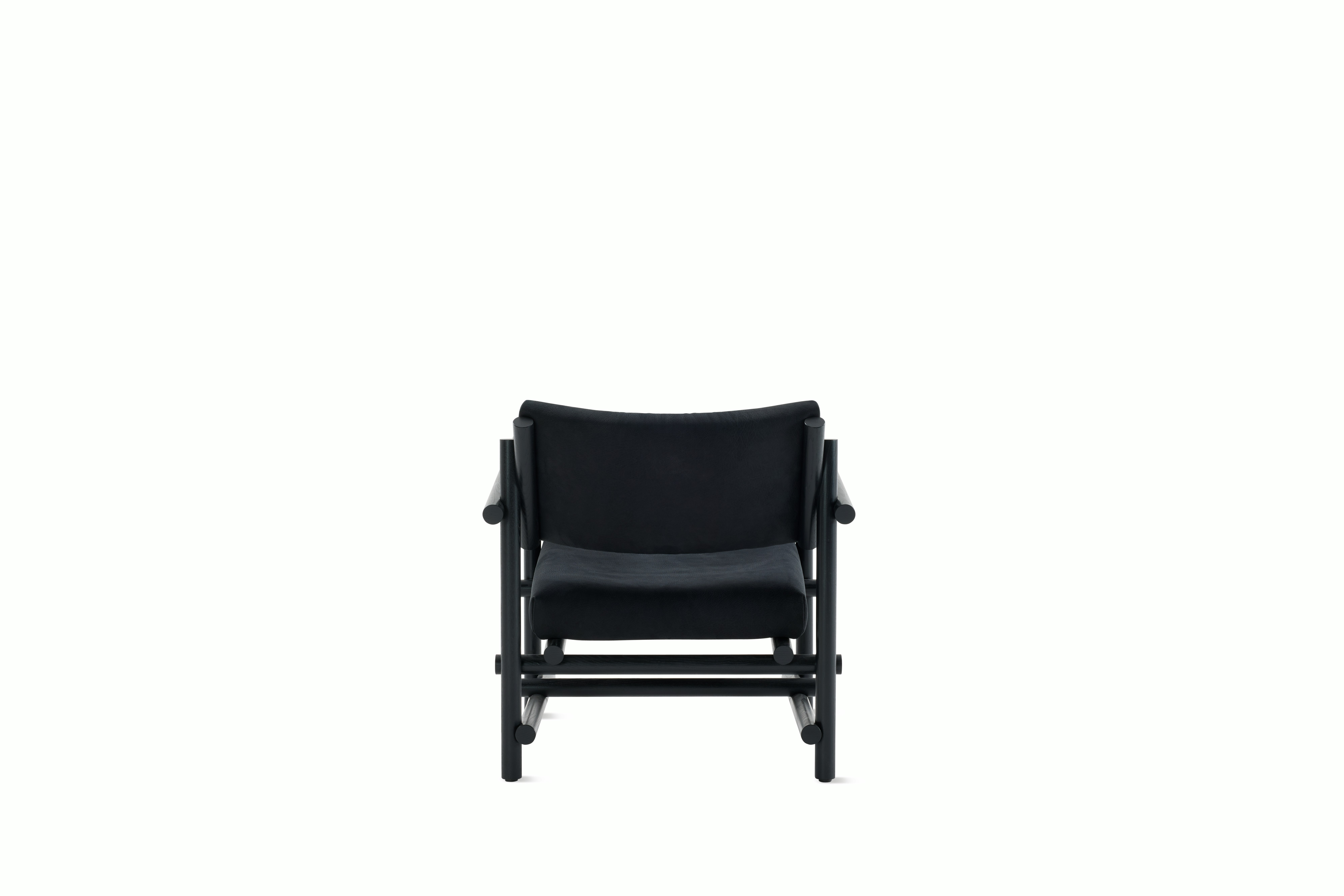 A Muecke Lounge Chair in Lava Black Ebonized Ash viewed from behind.