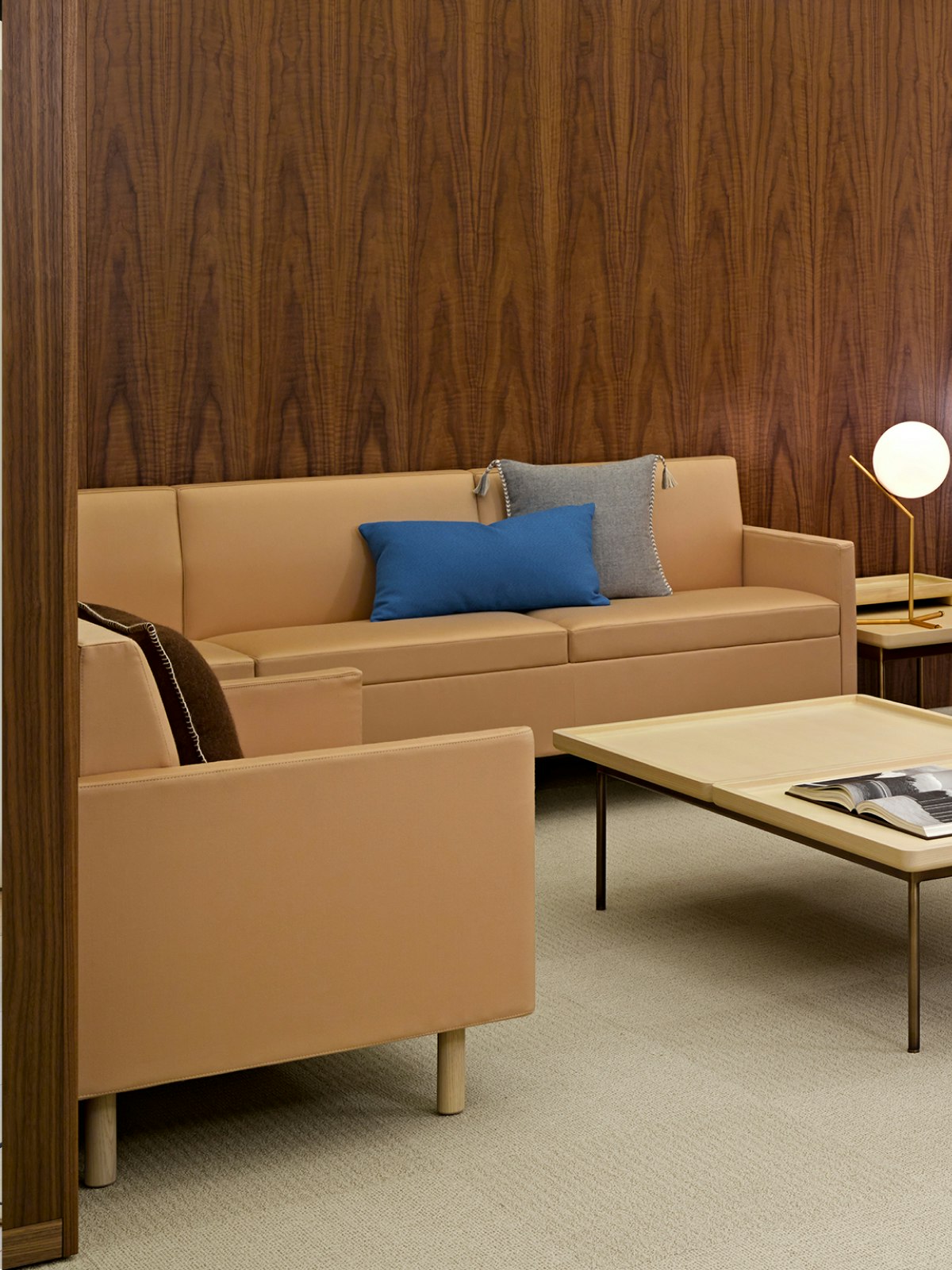 A sitting area featuring a Tuxedo Classic Sectional Sofa in light brown leather upholstery.