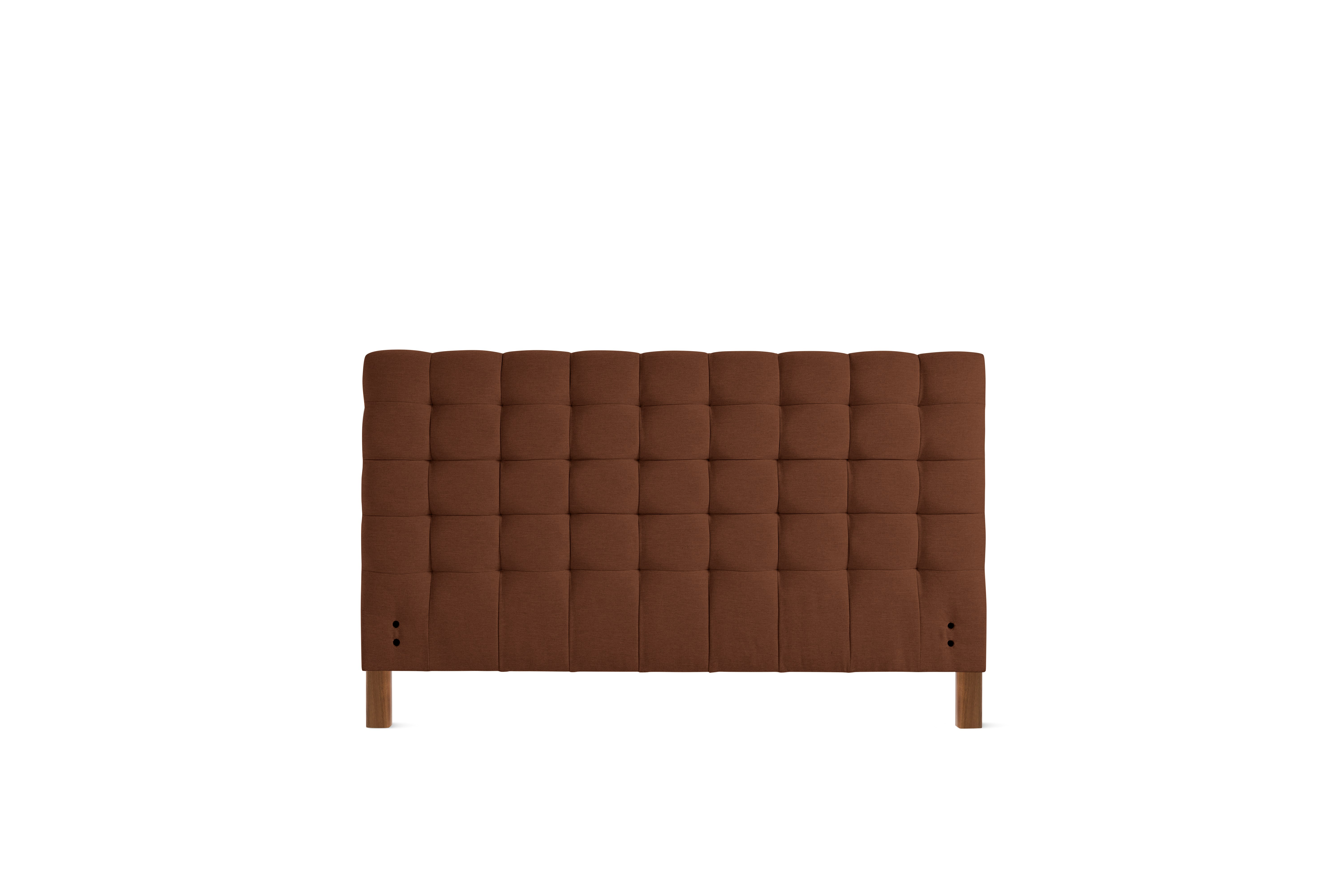 A Madeleine Headboard in Mode, Pathway, Walnut viewed from the front.