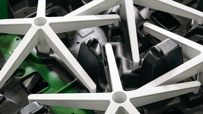 A close-up shot of office chair bases in a white finish.