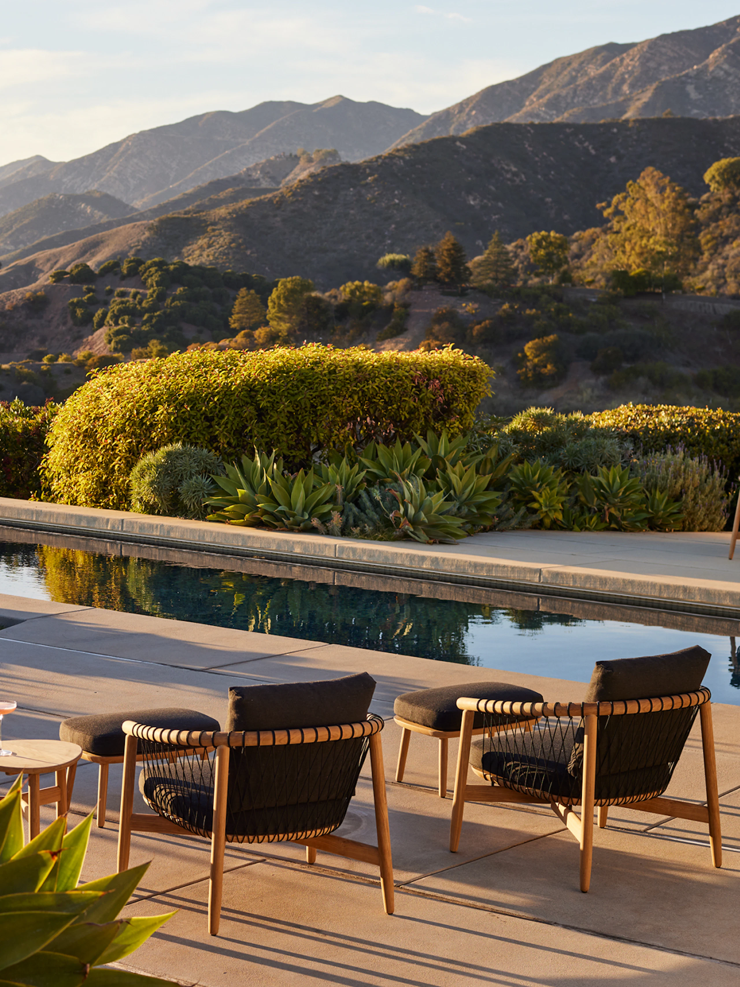 Crosshatch Outdoor Lounge Chairs with Ottomans in an environmental setting by the pool.