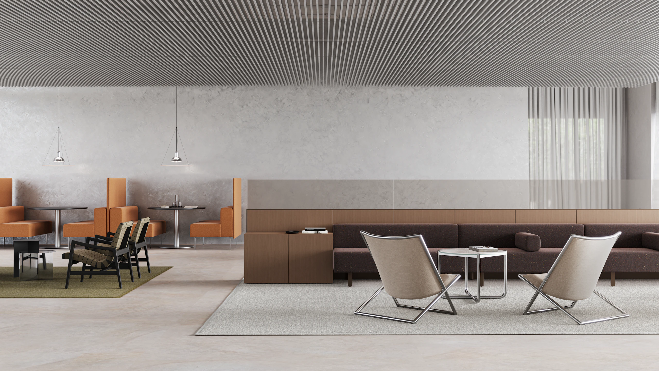 An open office with casual meeting spaces including booth style tables, lounge seating and upholstered benches.