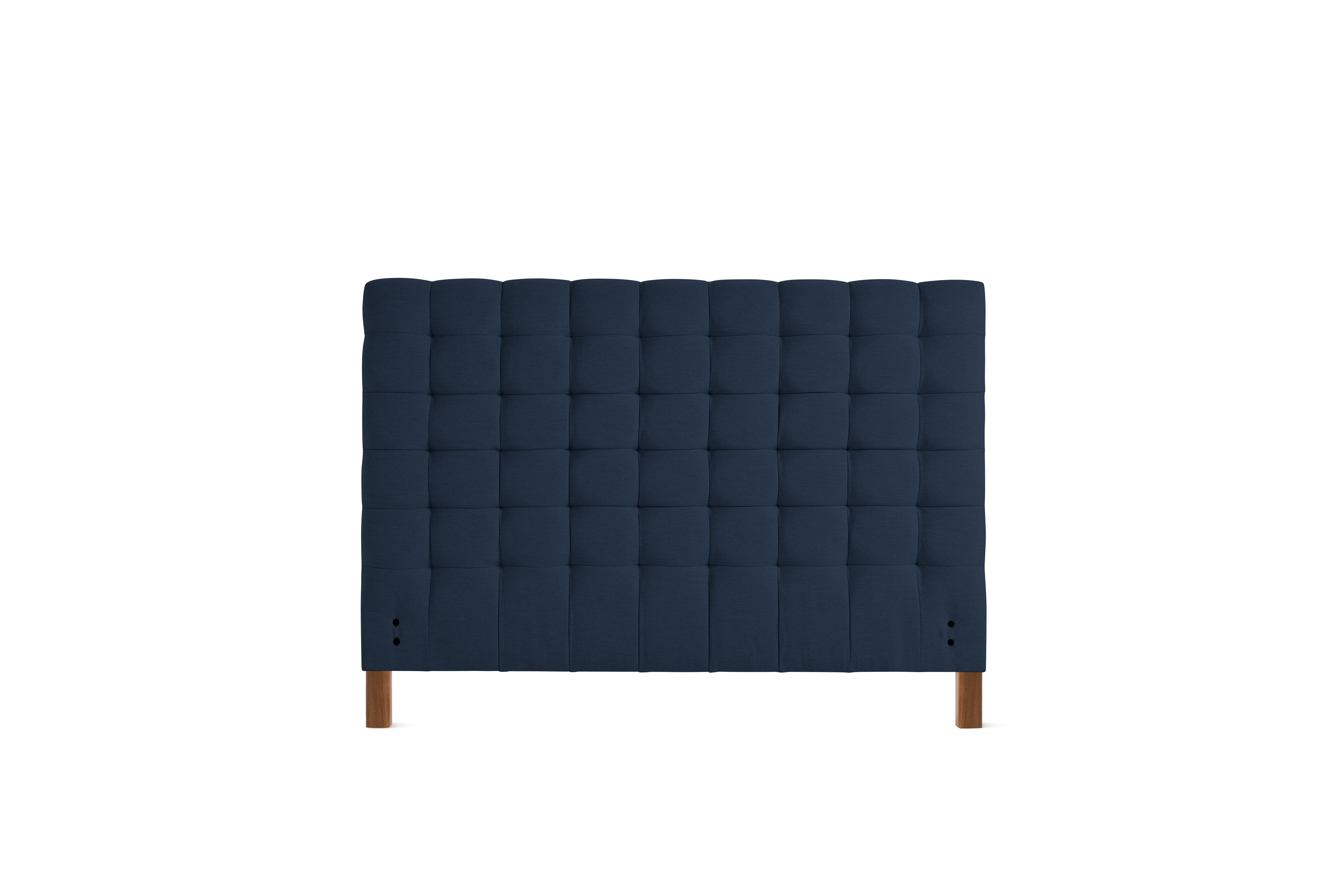 A Madeleine Headboard in Mode, Society, Walnut viewed from the front.