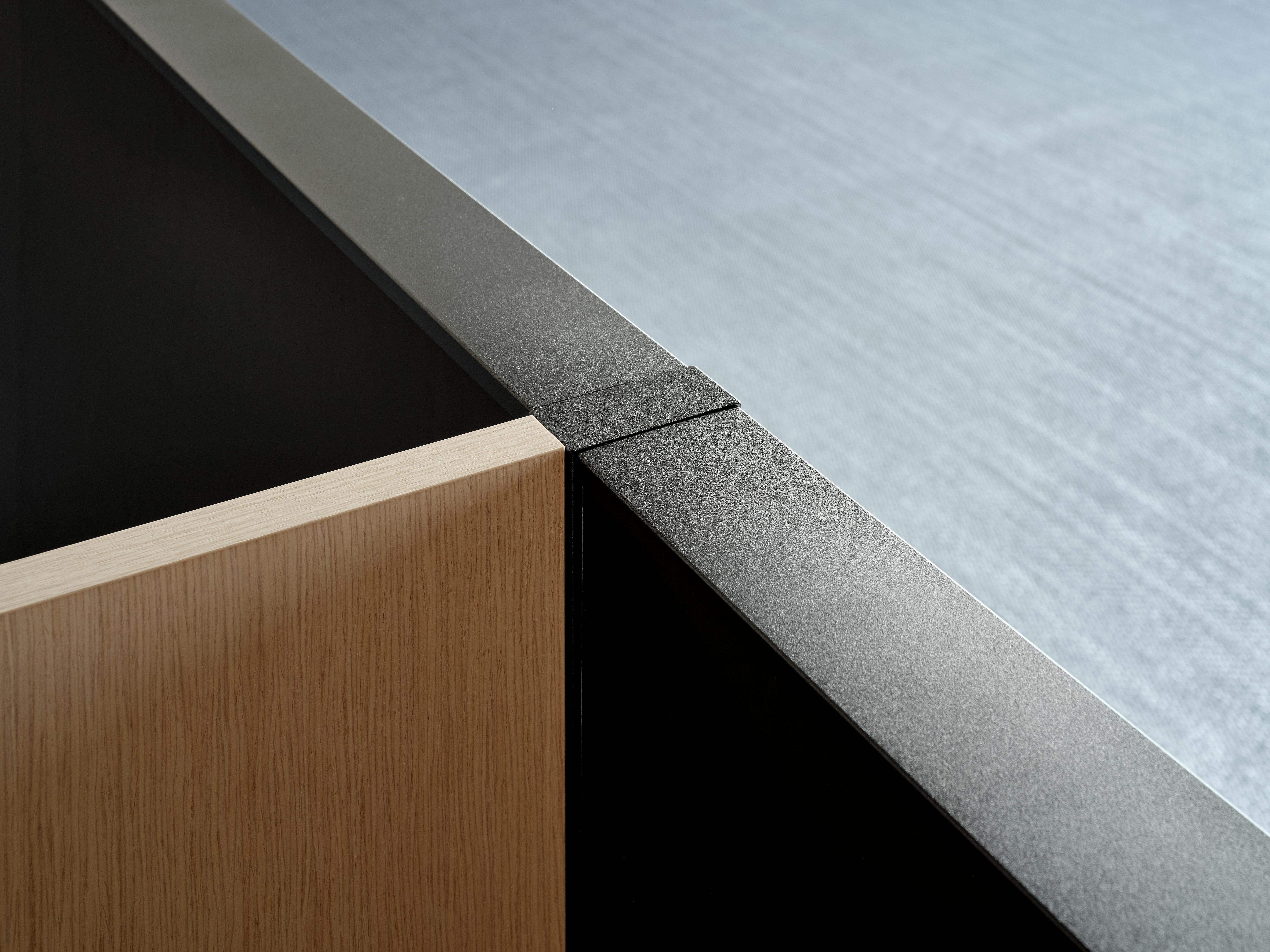 An up close view of a veneer screen joining at a 90 degree angle with a system panel.