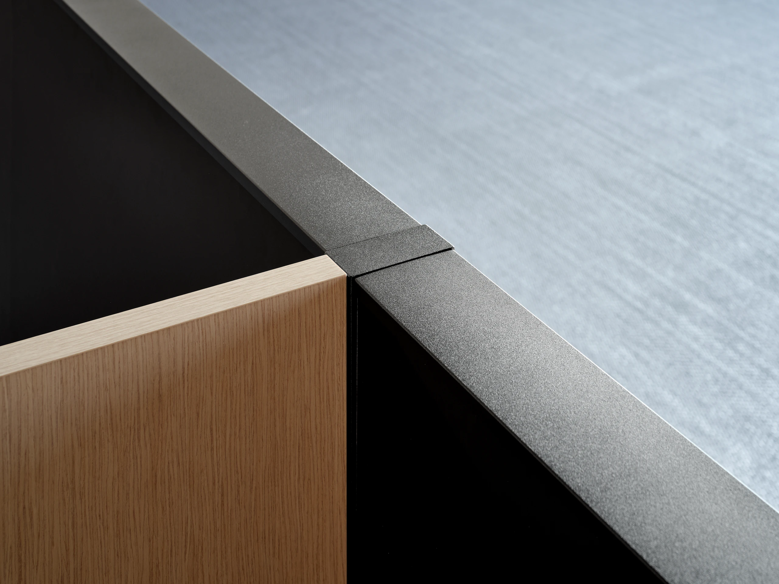 An up close view of a veneer screen joining at a 90 degree angle with a system panel.