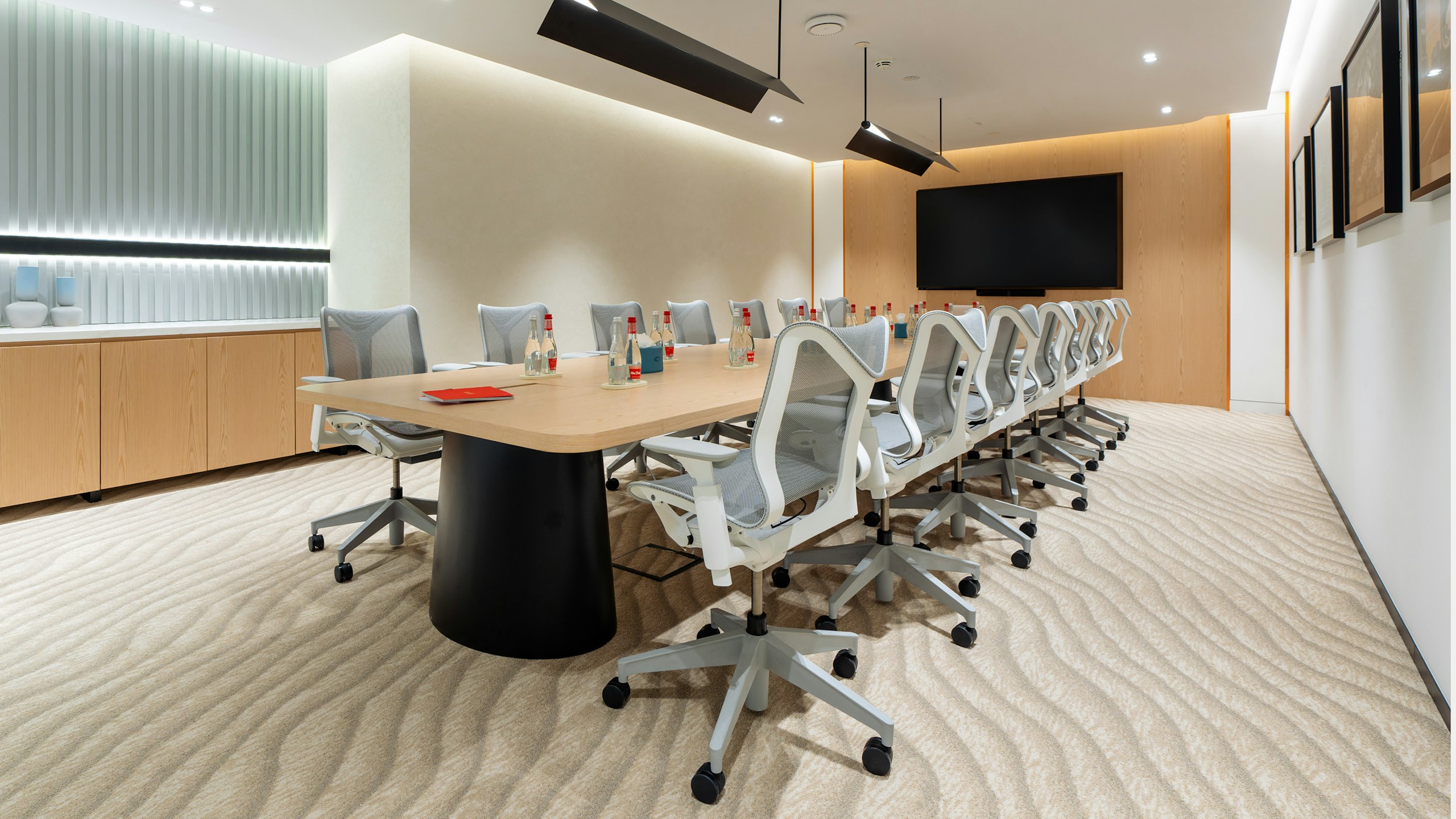 Meeting room with long table surrounded by low back Cosm Chairs.