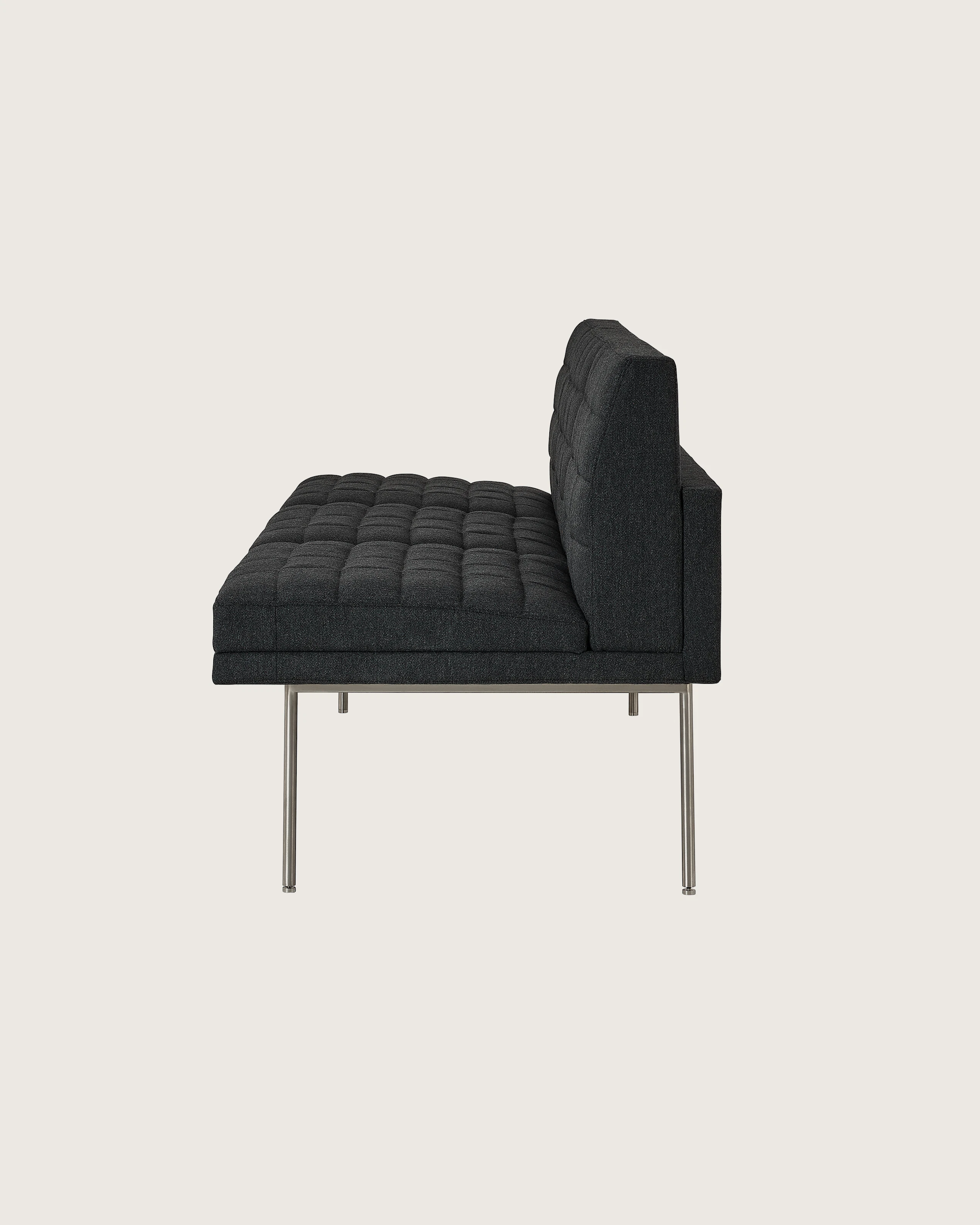 Tuxedo Component Sofa designed by BassamFellows upholstered in Bellano in Charcoal with a polished chrome base, shown in profile on a white sweep.