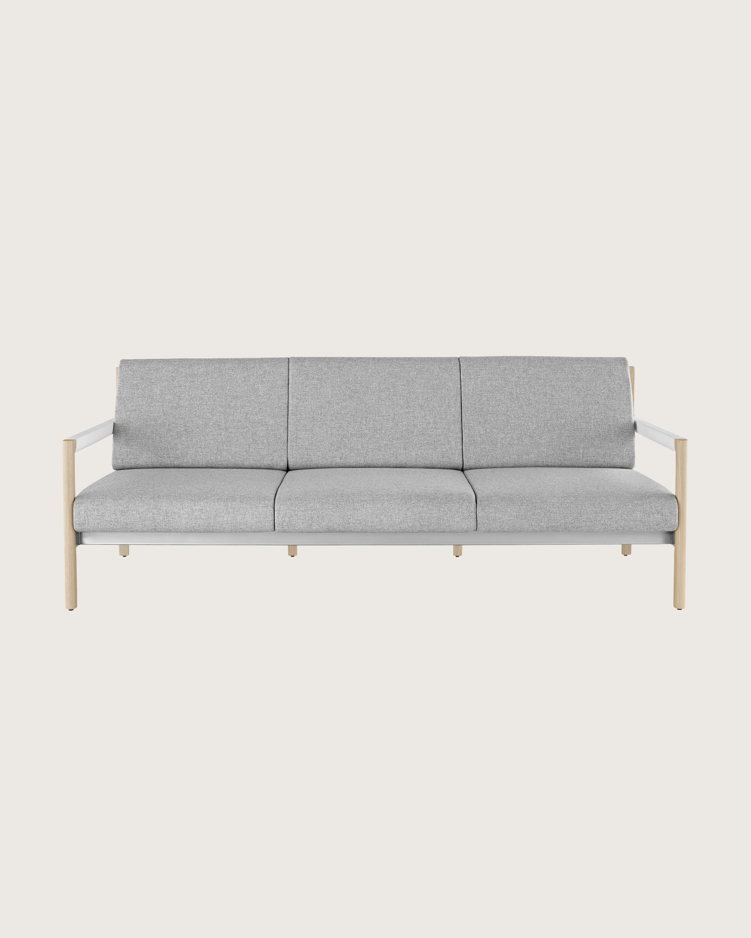 A Brabo sofa with Clare light gray upholstery, white leather-wrapped arms, metal accents, and a light wood frame, viewed from the front.