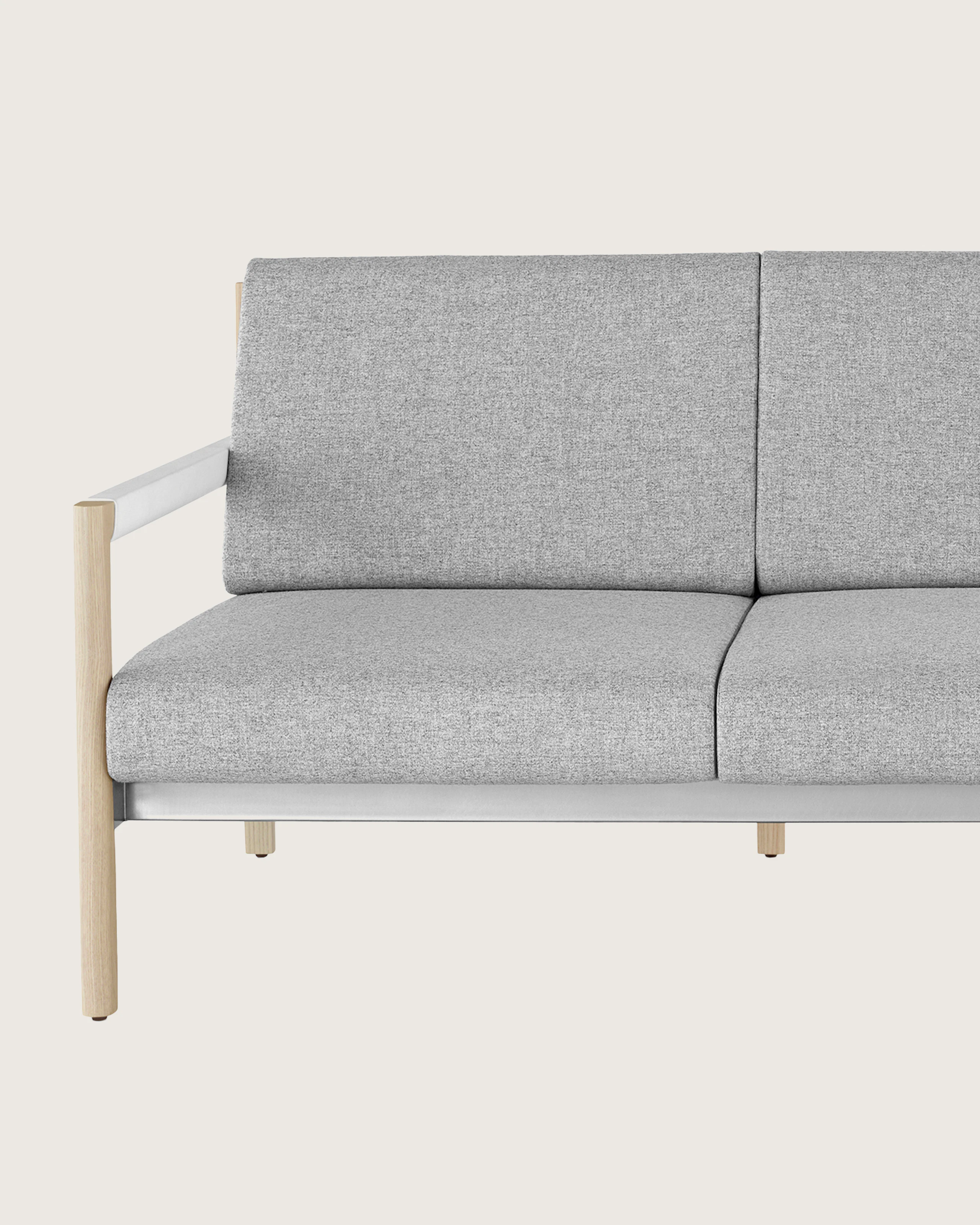 A Brabo sofa with Clare light gray upholstery, white leather-wrapped arms, metal accents, and a light wood frame, viewed from the front.