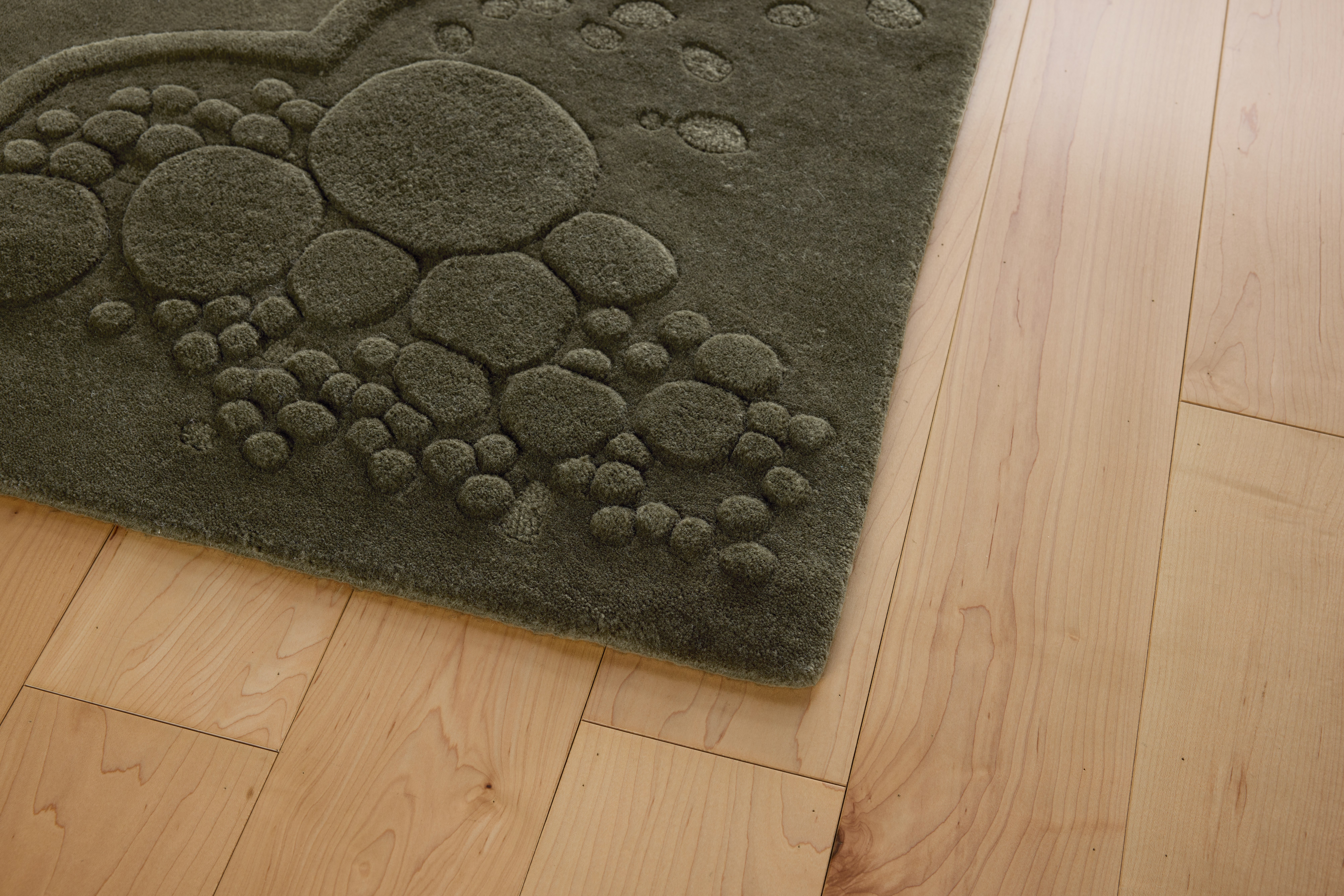A detailed look at a Nebula SuperLuxe Rug in Dark Green.