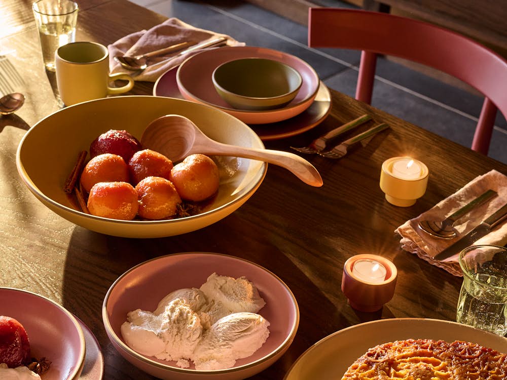 Land Table in oak with red comma chairs surrounding, and Heath earthenware on top