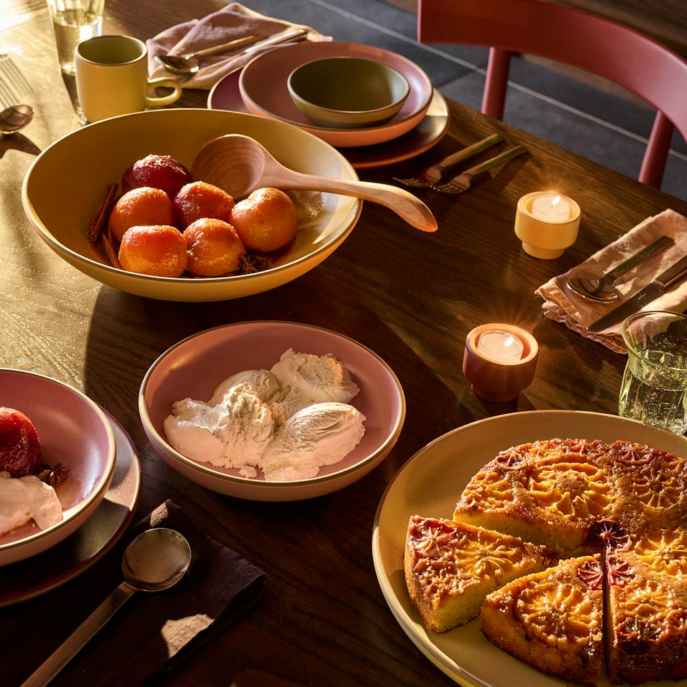 Land Table in oak with red comma chairs surrounding, and Heath earthenware on top