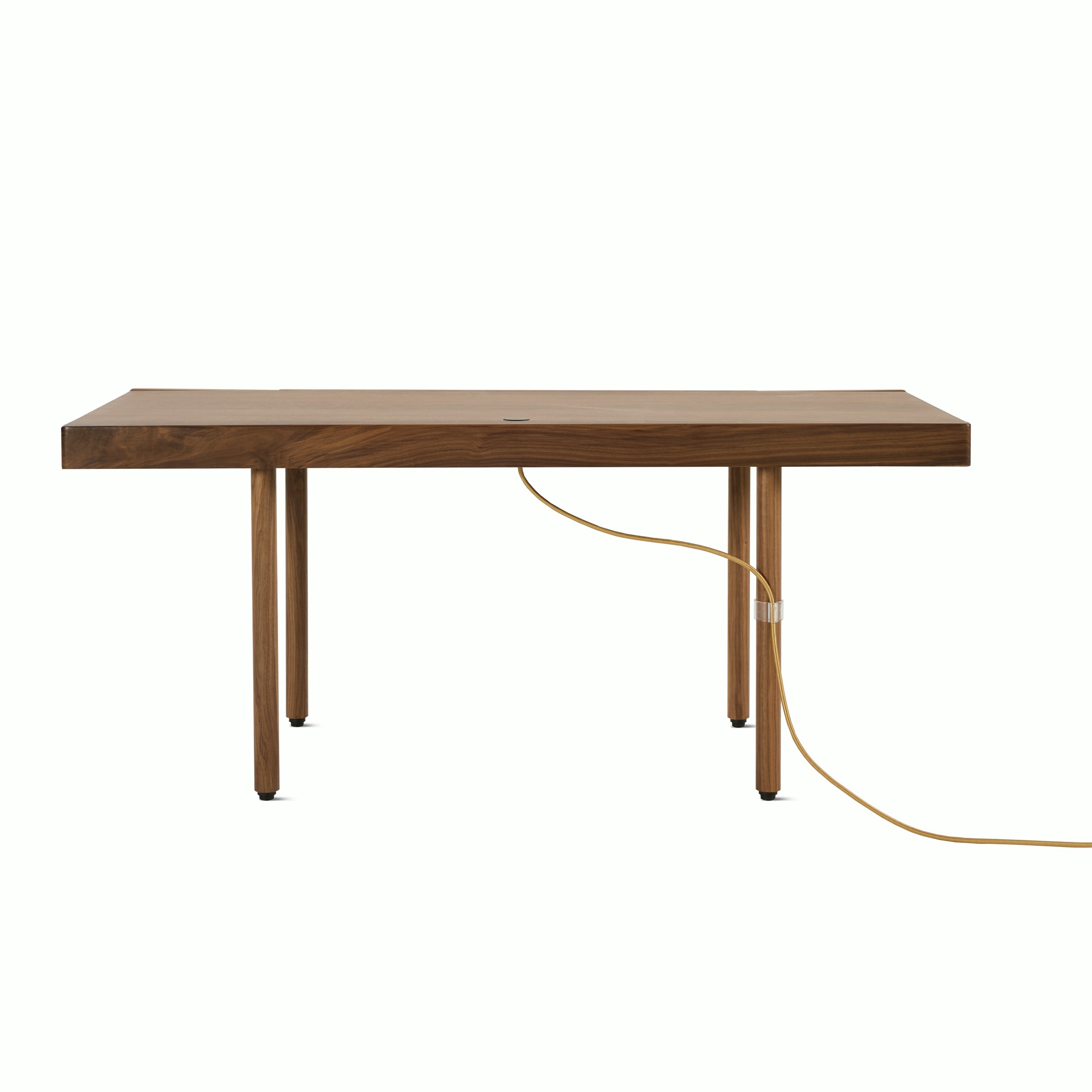A New Canaan Wood Sit-to-Stand Desk in Walnut viewed from behind.