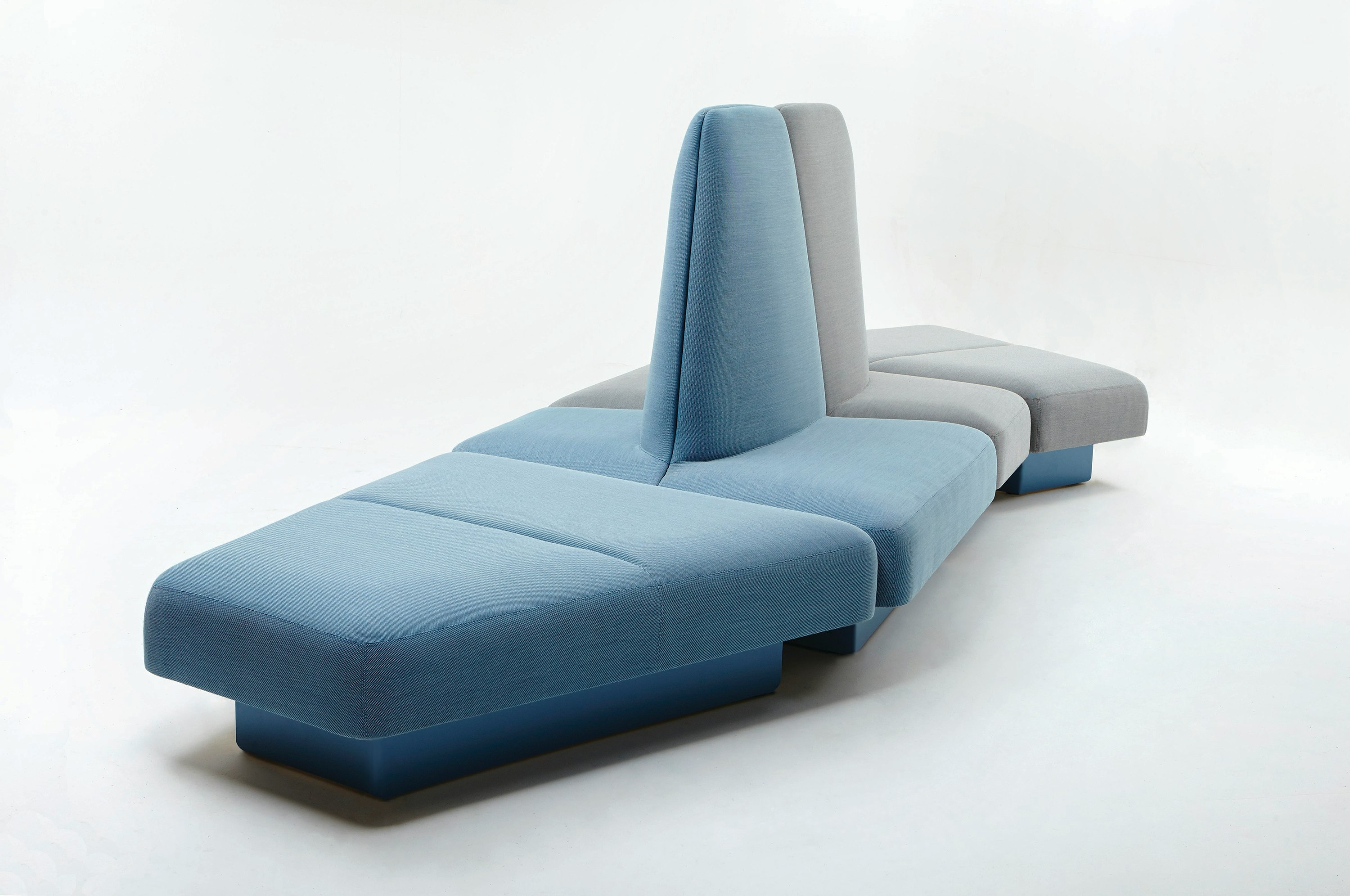 A naughtone Rhyme Modular Seating unit made of blue and gray pieces, viewed at an angle.