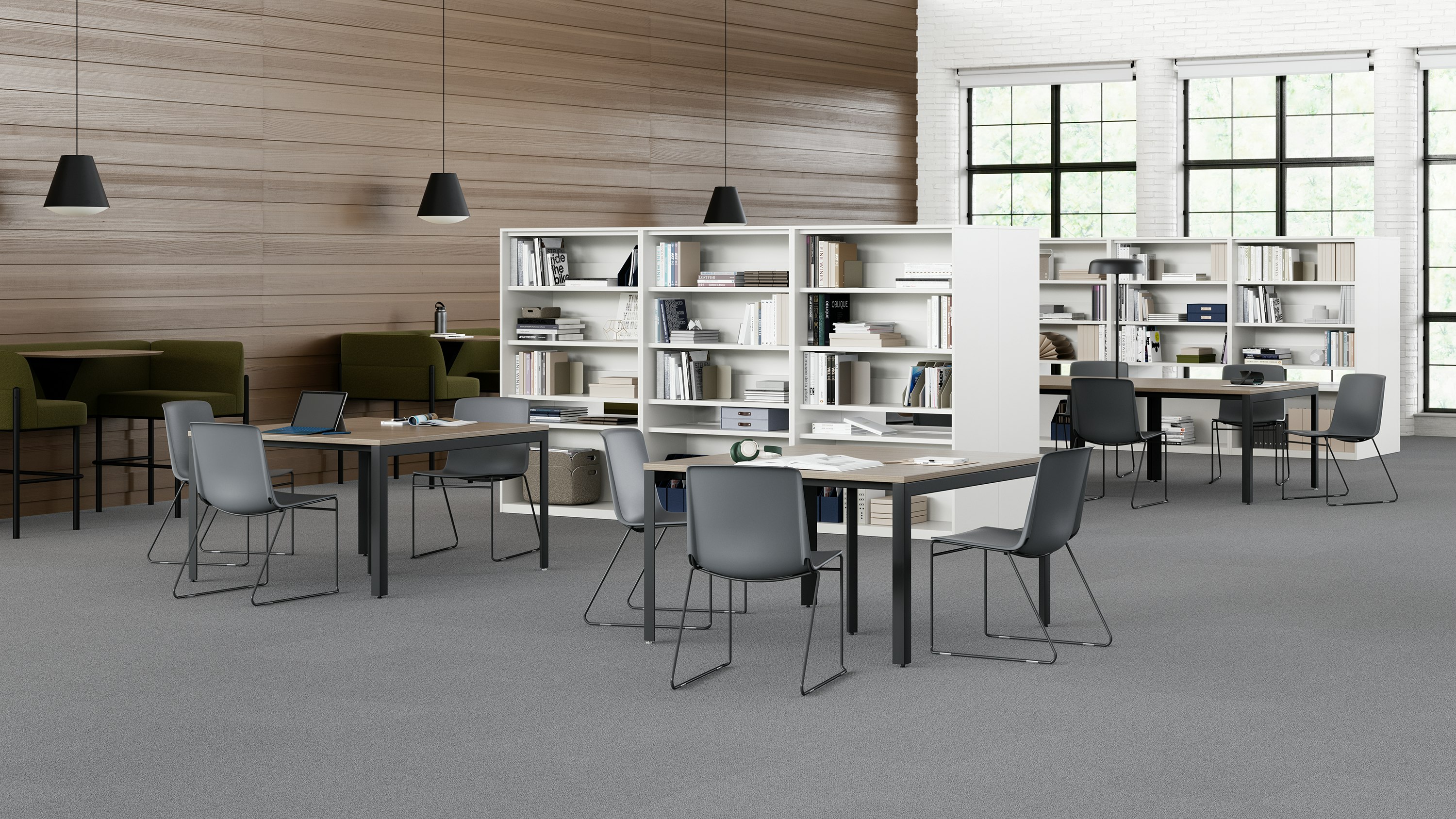 Grey Pronta Stacking Chairs in a library space with Layout Studio Tables and a naughtone Hue Booth.
