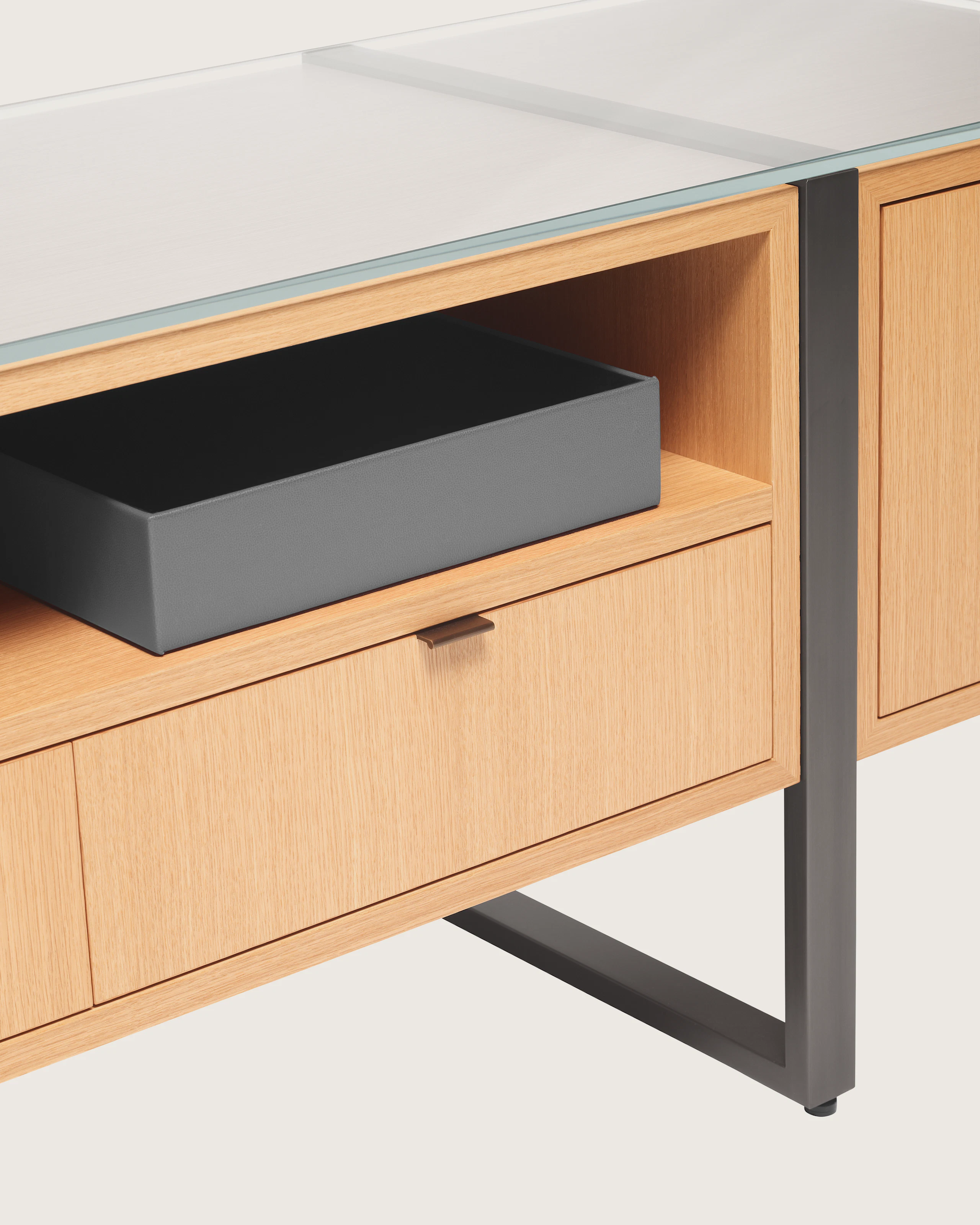 Highline Credenza in Rift Cut European White Oak with Clear Glass top and Gunmetal Grey Metal legs, detail view.