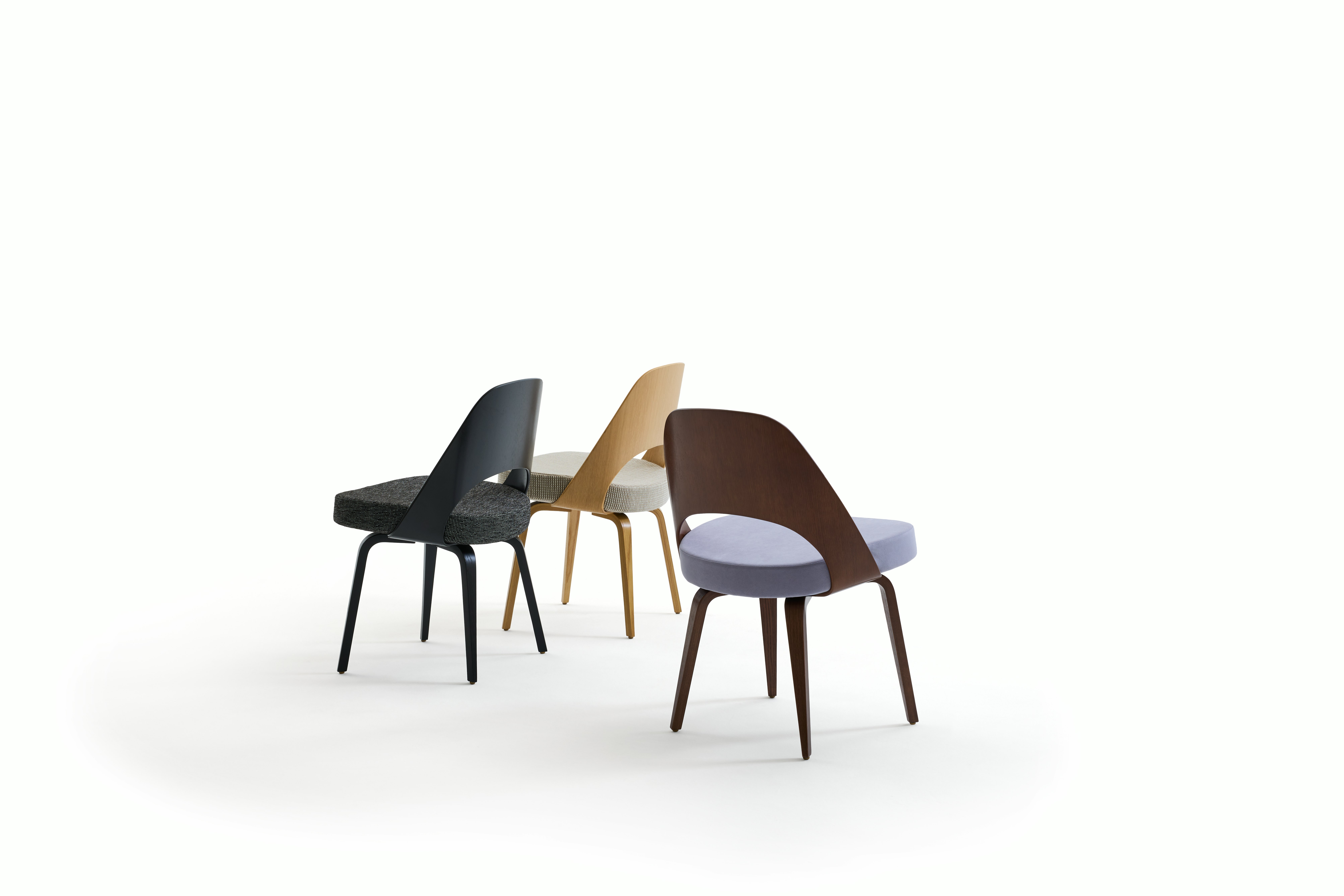 There Saarinen Executive Chairs with wood backs and legs.