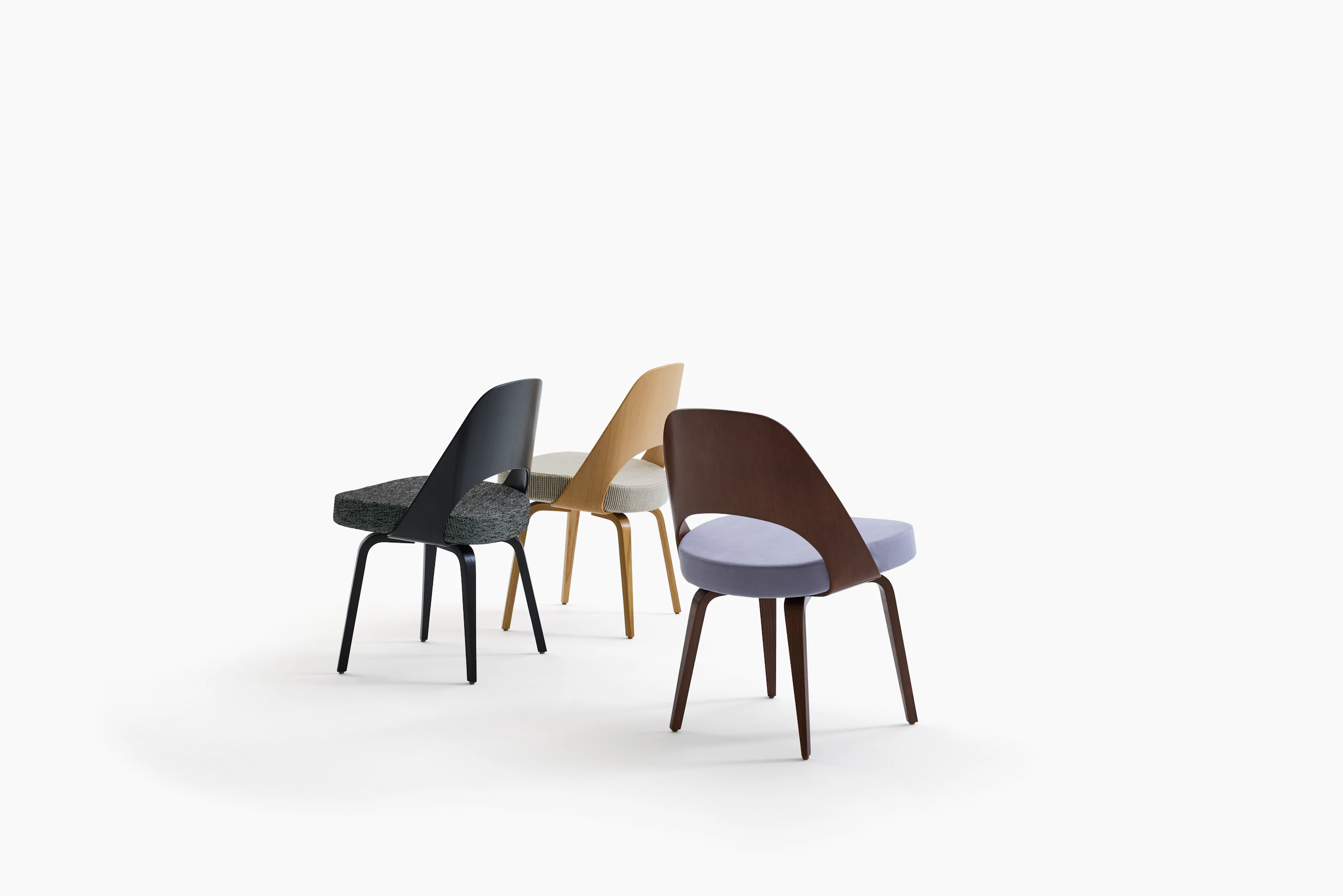 There Saarinen Executive Chairs with wood backs and legs.