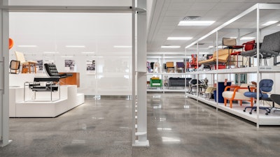 A split view of the MillerKnoll Archives showing pedestals about iconic pieces of the collective in one room and rows of white shelves displaying a range of furniture from MillerKnoll in another