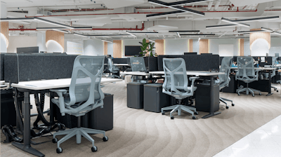An open plan office with groups of Altas desks and Cosm Chairs.