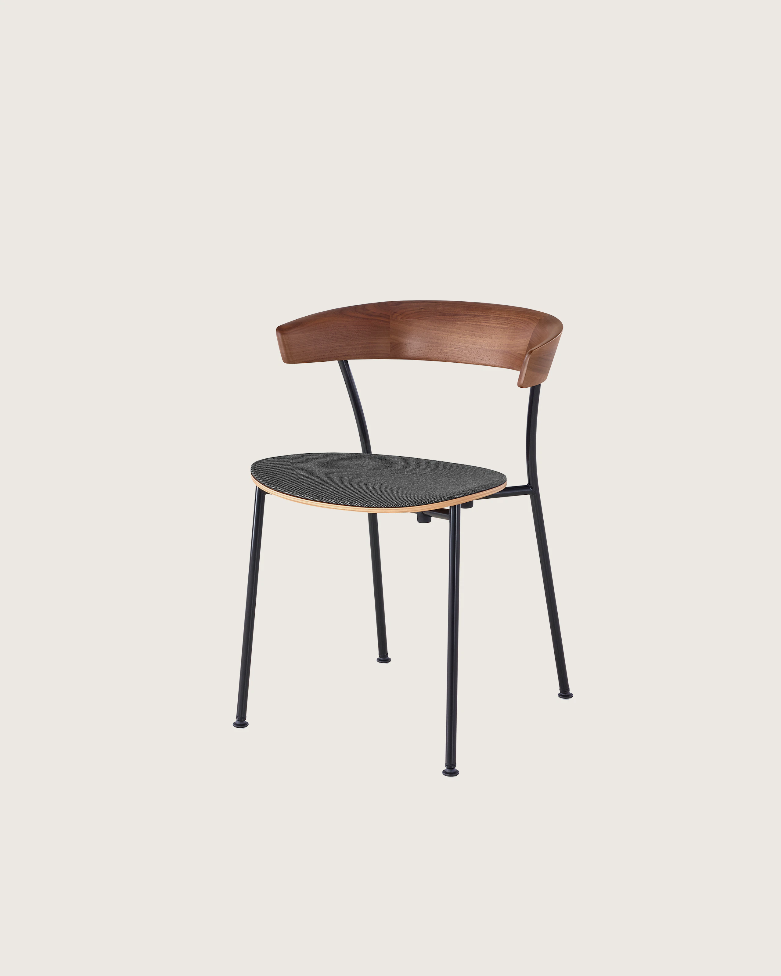 Angled view of a stackable Leeway Chair with a metal frame, curved wood backrest, and upholstered seat.