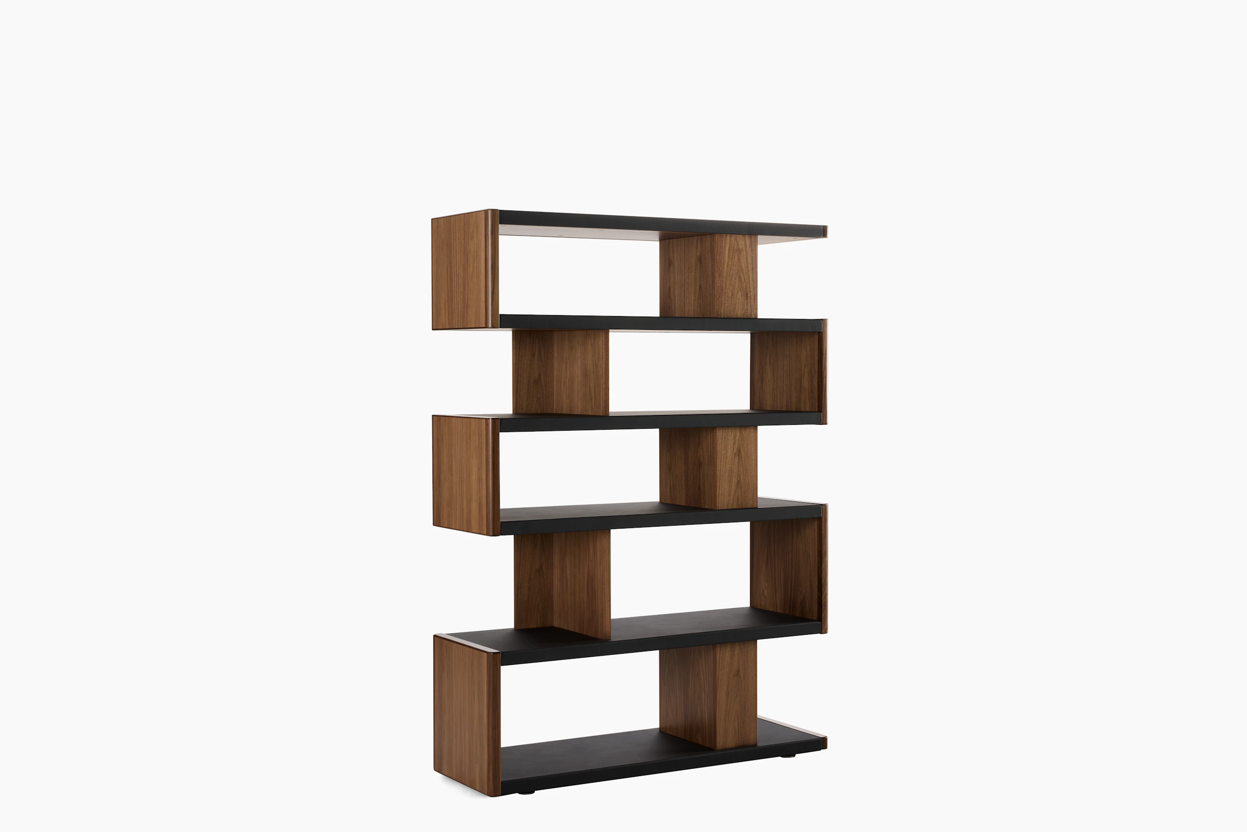 New Canaan High Bookshelf designed by BassamFellows for Geiger in Walnut with Black Leather shown angled on a white sweep.