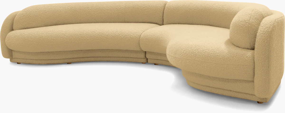 L-shaped beige modular sofa with rounded armrests and matching cushions