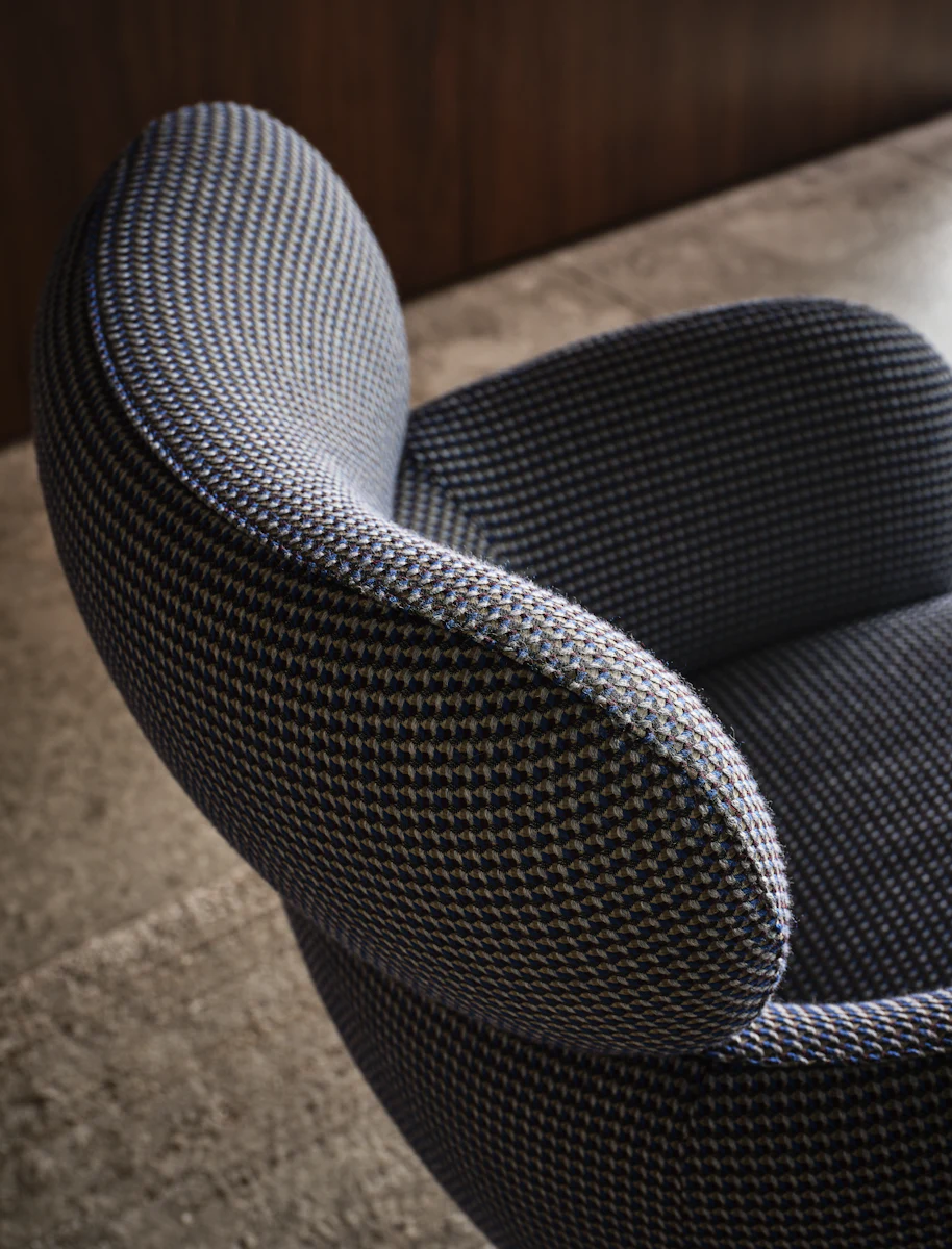 Teal/green upholstered swivel chair with a high back and a metal pedestal base with four legs, shown from the front.