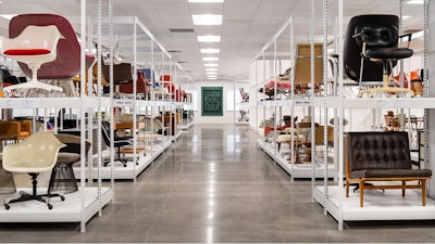 Rows of white display shelves at the MillerKnoll Archives featuring historic pieces of furniture from the MillerKnoll collective of brands