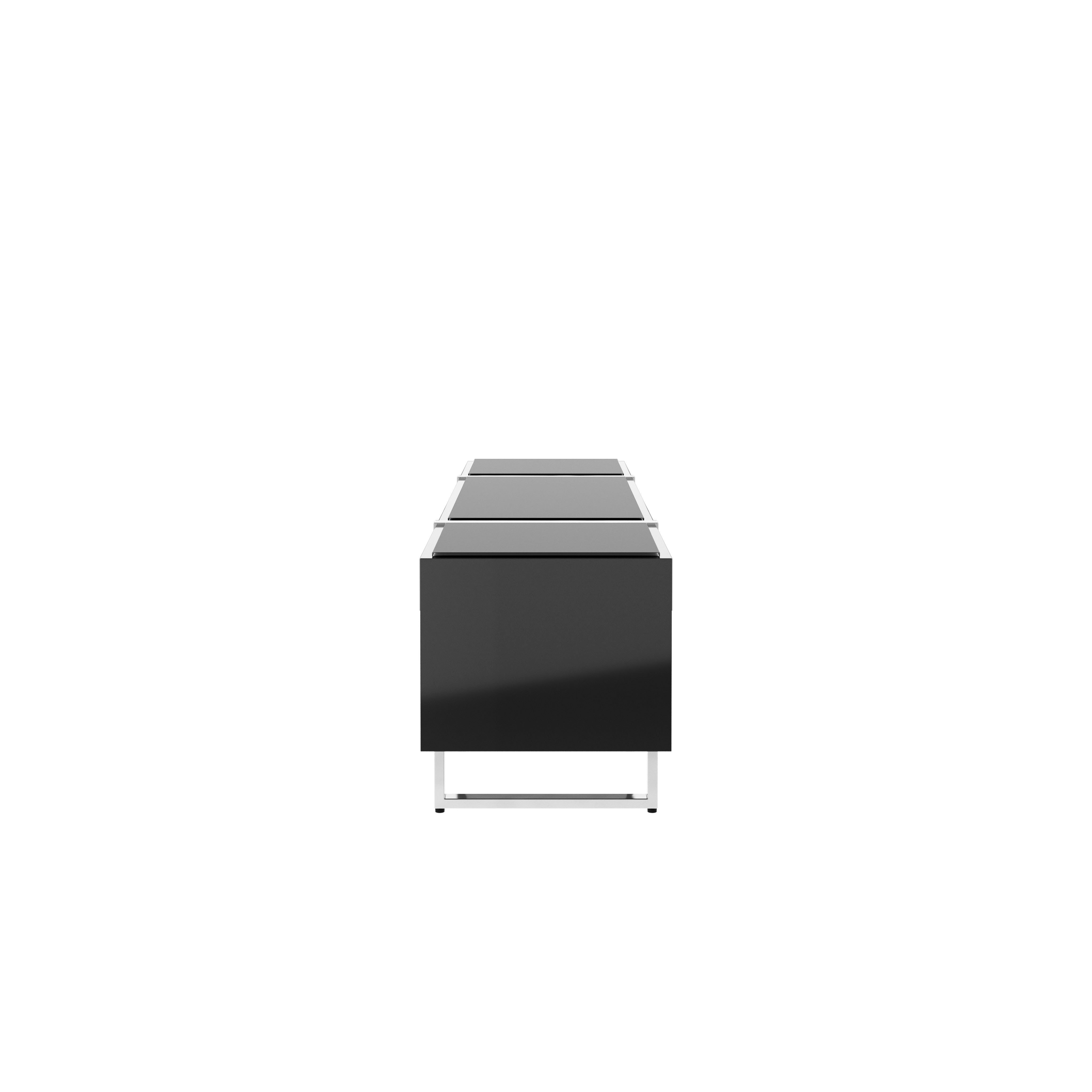 Highline Credenza in Black Polyester with Clear Black Backpainted Glass top and Polished Chrome legs viewed from the side.