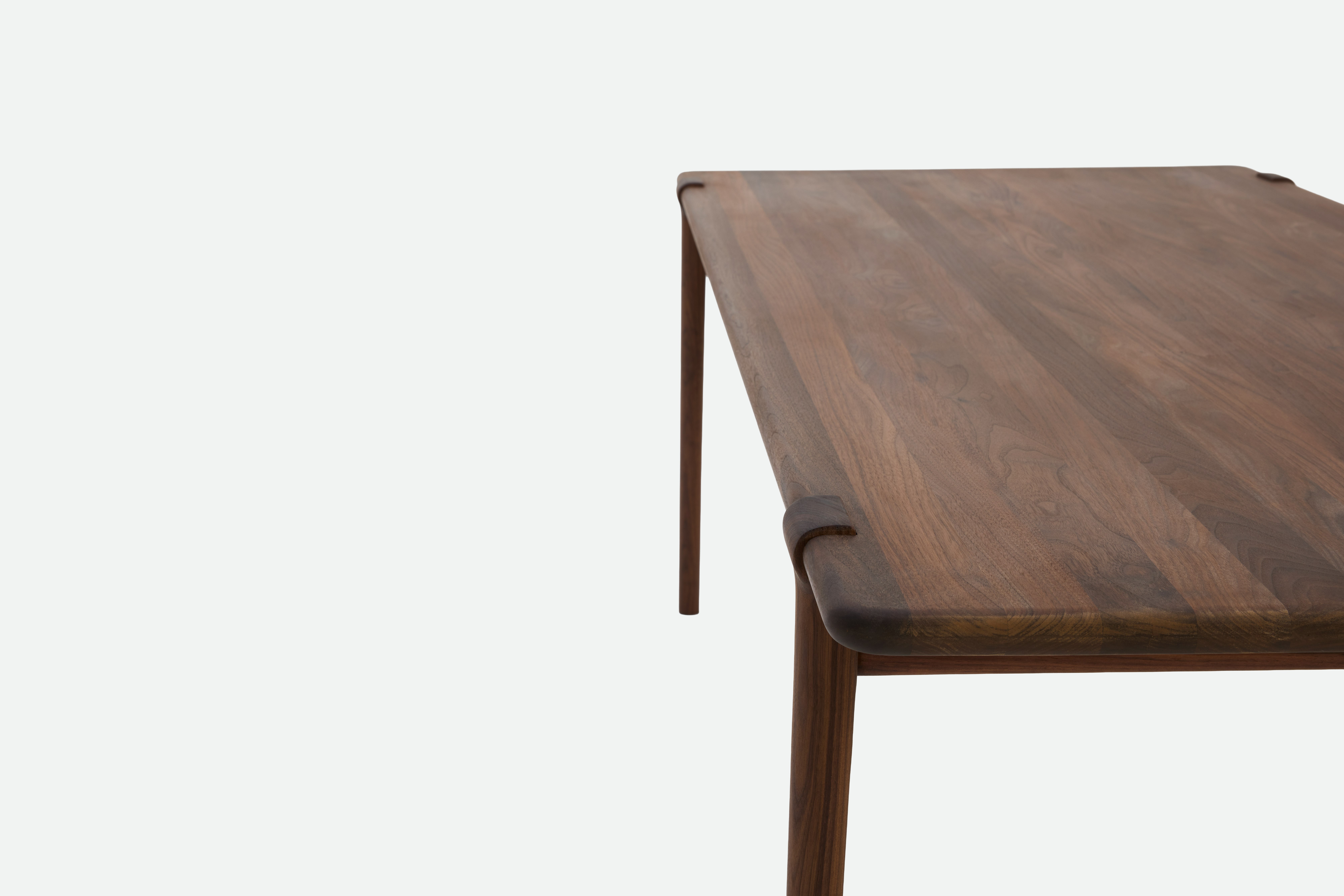 A detailed look at an Otto Dining Table in Walnut.