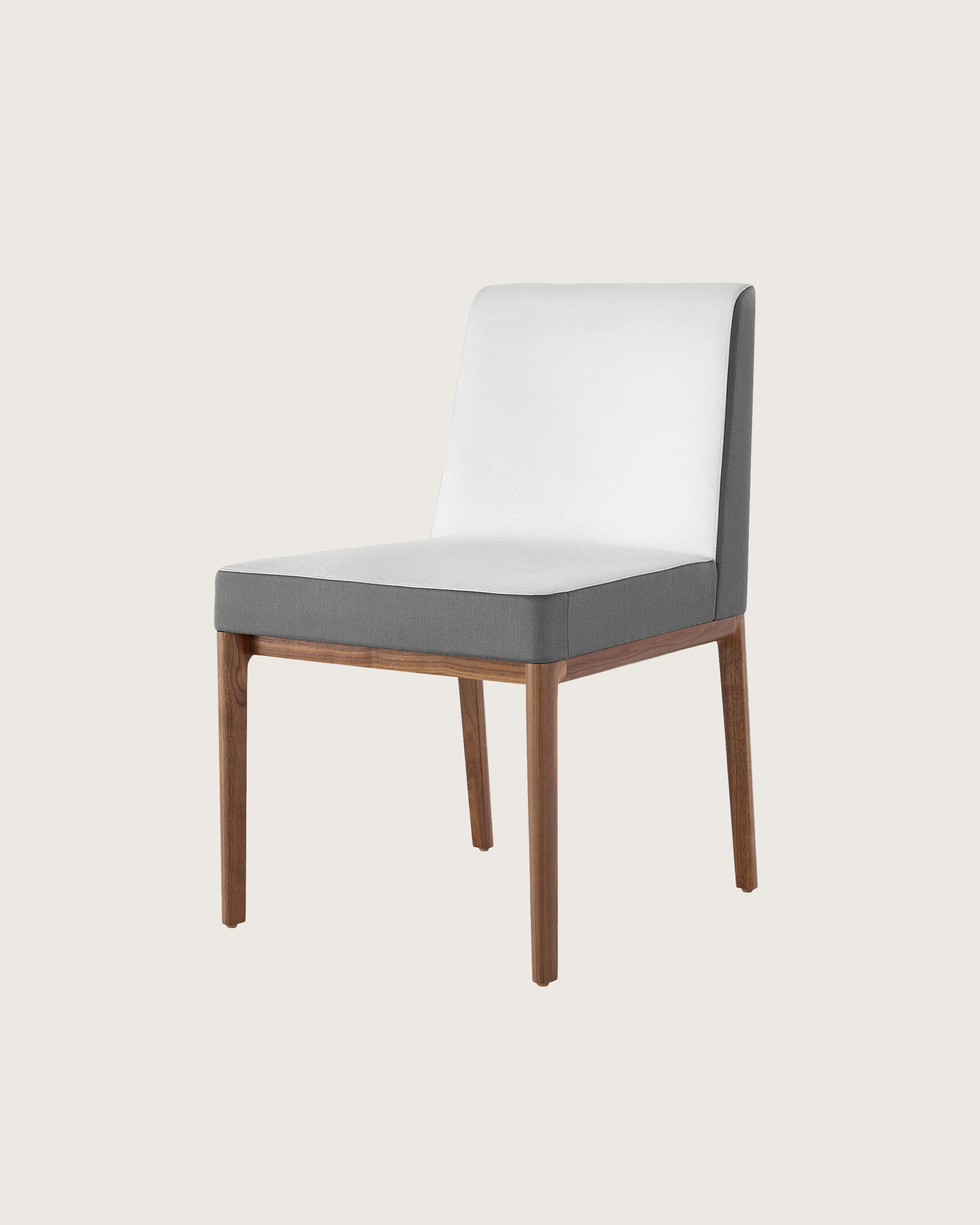 Angled view of an armless Nessel side chair with two-tone upholstery in off-white and gray.