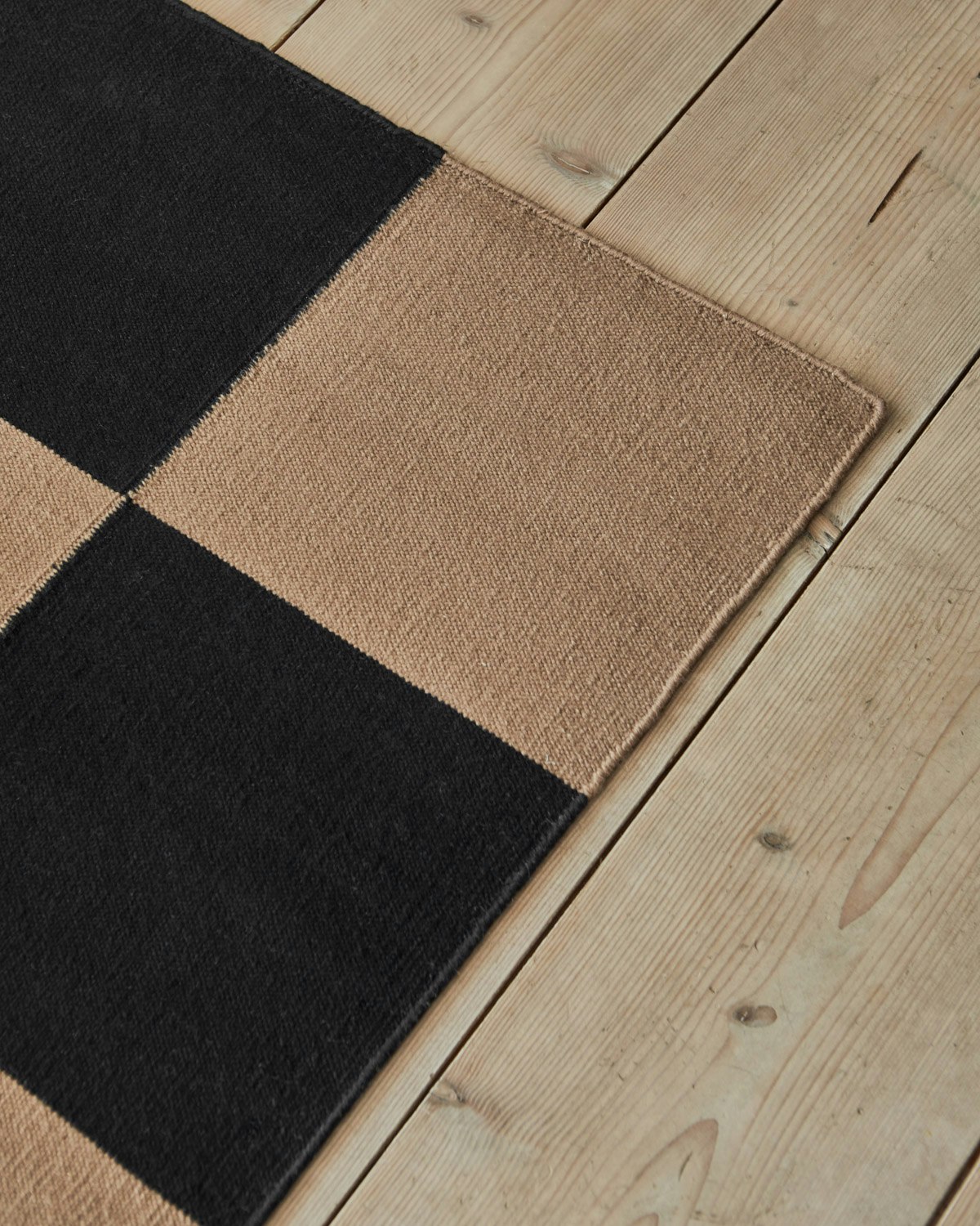 An environmental shot of the Square Flatweave Rug in Tobacco.