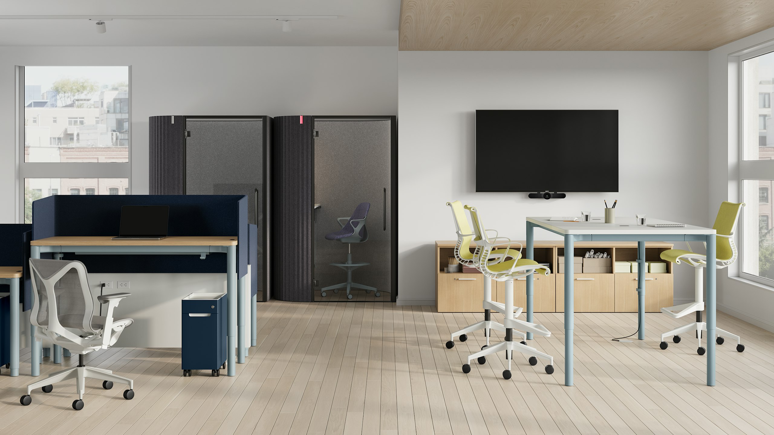 4-leg height-adjustable tables used to support individuals and teams both feature a light blue base and show both light woodgrain surface with a dark blue screen, and white surface.