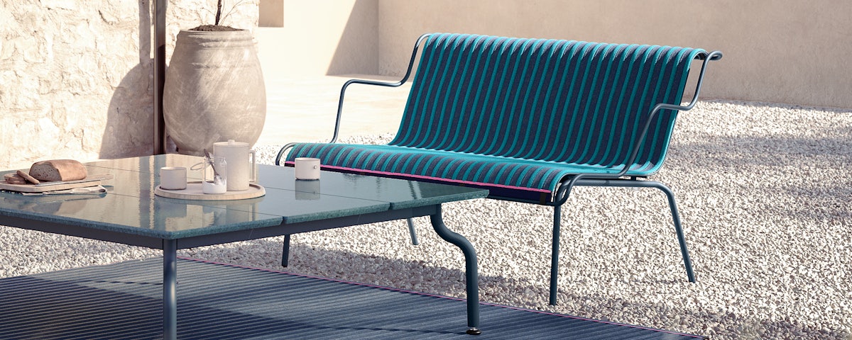 South Outdoor Lounge Bench with Arms in an outdoor patio setting