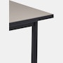 Detail view of the sandstone laminate top on a black Mode desk.