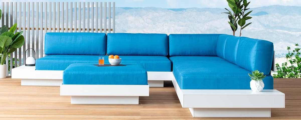 Platform One Ottomon in front of a Platform One Sectional on and outdoor wooden deck