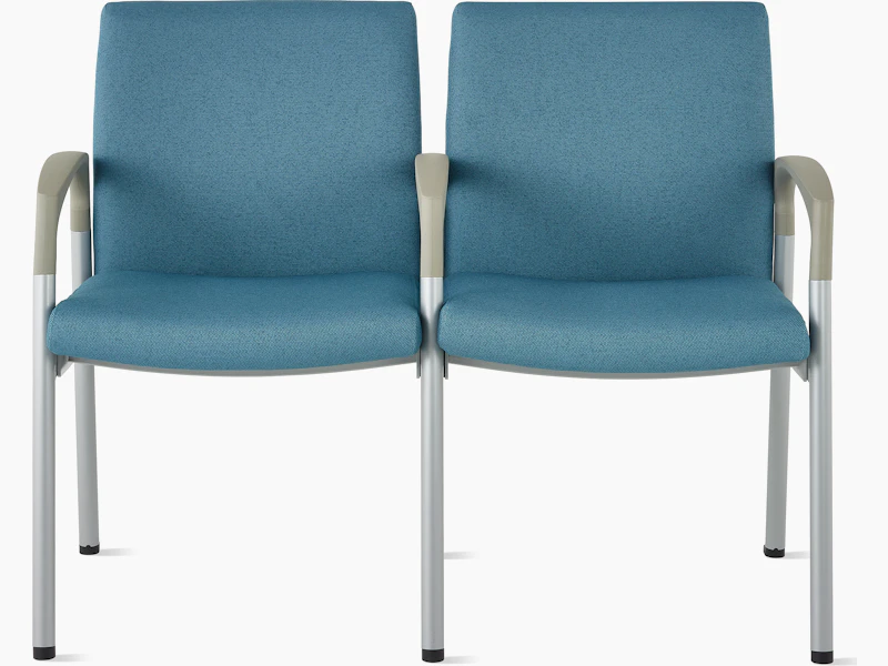 Front view of Valor two-seat multple seating with intervening arms and legs in a blue upholstery, silver frame, and pewter armcaps on white sweep.