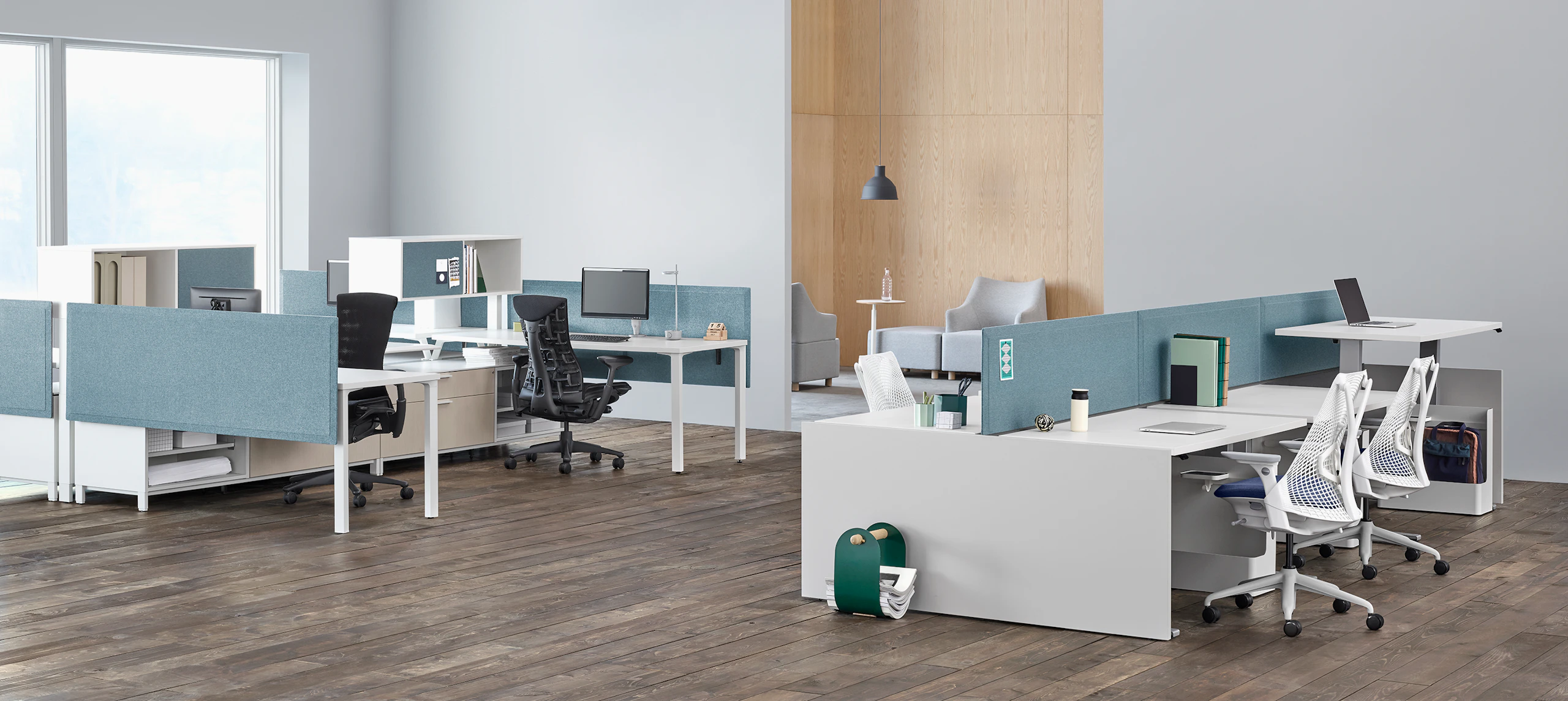 Office with Canvas Channel and Canvas Dock workstations with blue fabric screens, white desks near a lounge seating area