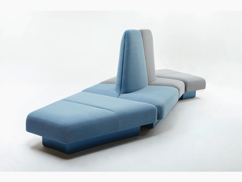 A naughtone Rhyme Modular Seating unit made of blue and gray pieces, viewed at an angle.