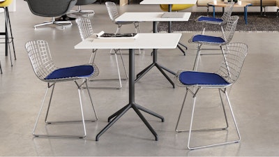 Two black and white Muuto Still Cafe tables feauting Knoll Bertoia chairs used to facilitate flexibility in a café setting