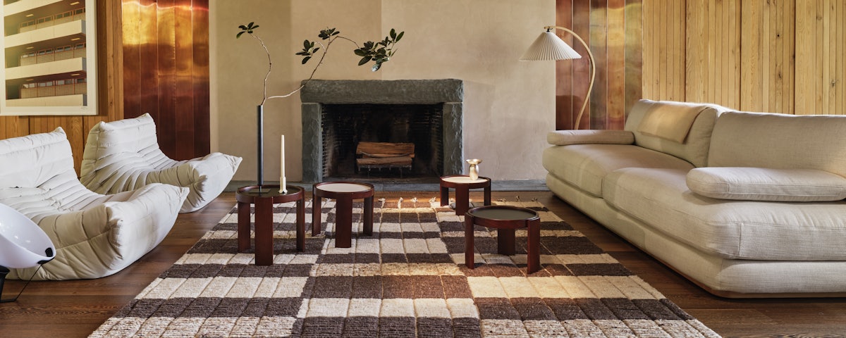 Bennett Rug, Stack Sofa, Togo Fireside Chairs, and 780 Nested Tables in a living room setting