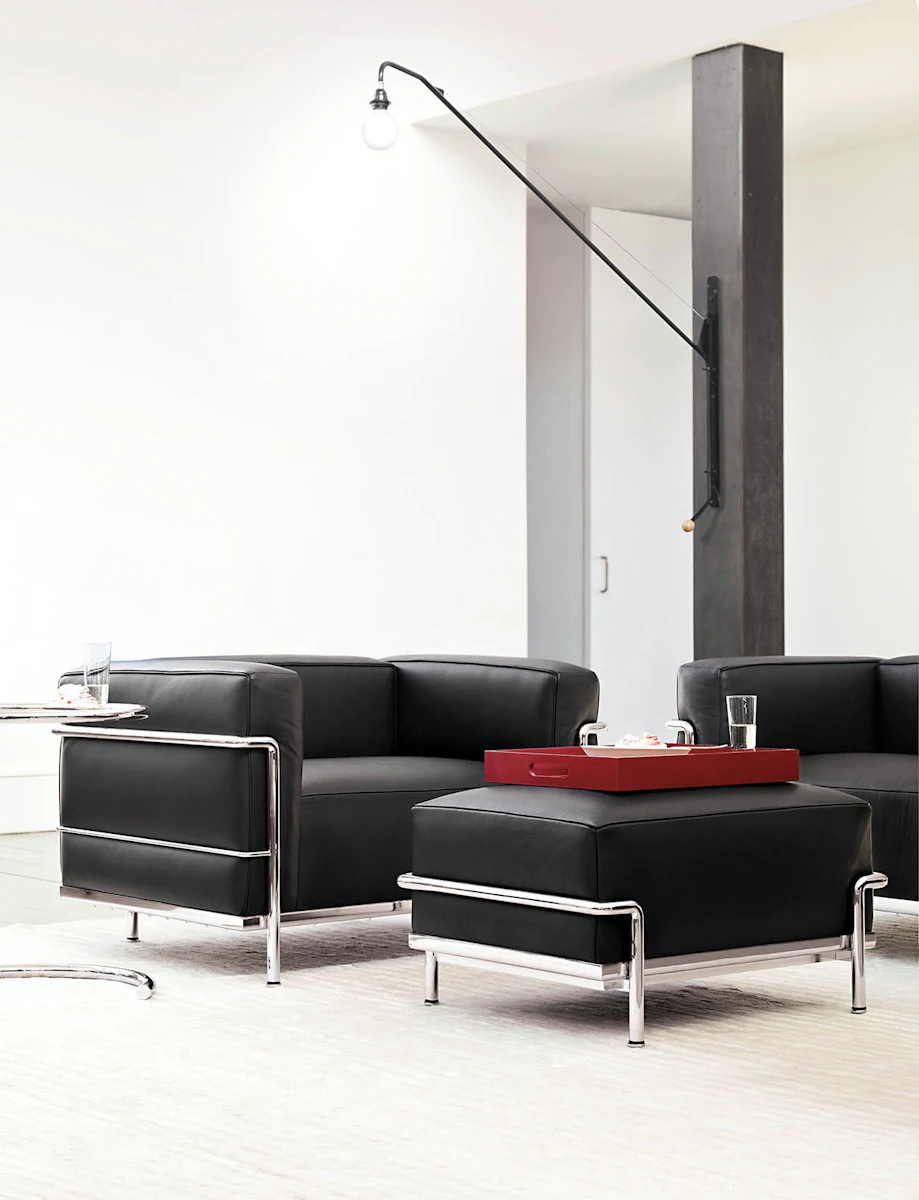 Front view of black leather armchair with chrome tubular arms and legs.