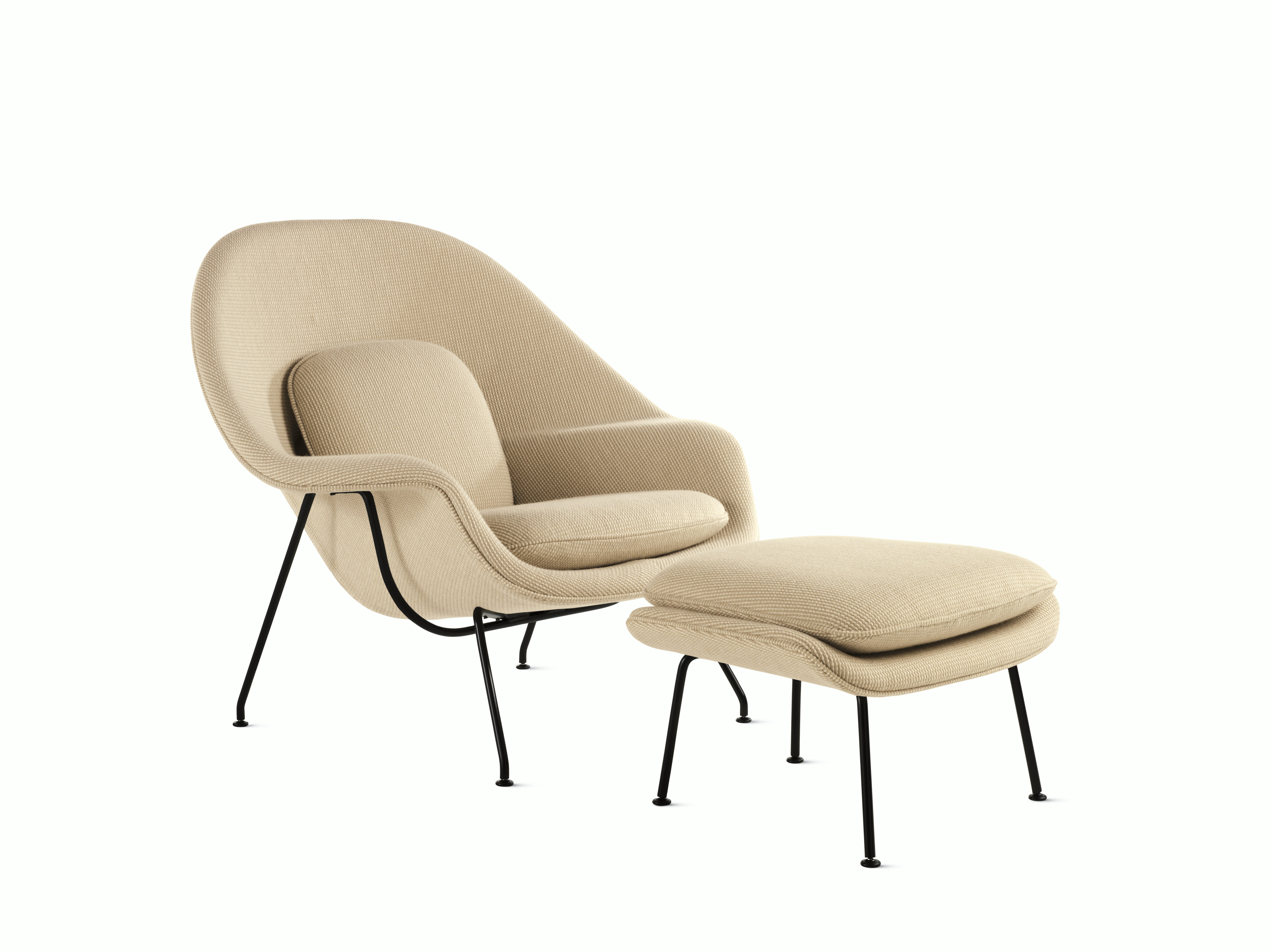 An ivory Womb Chair & Ottoman viewed from an angle