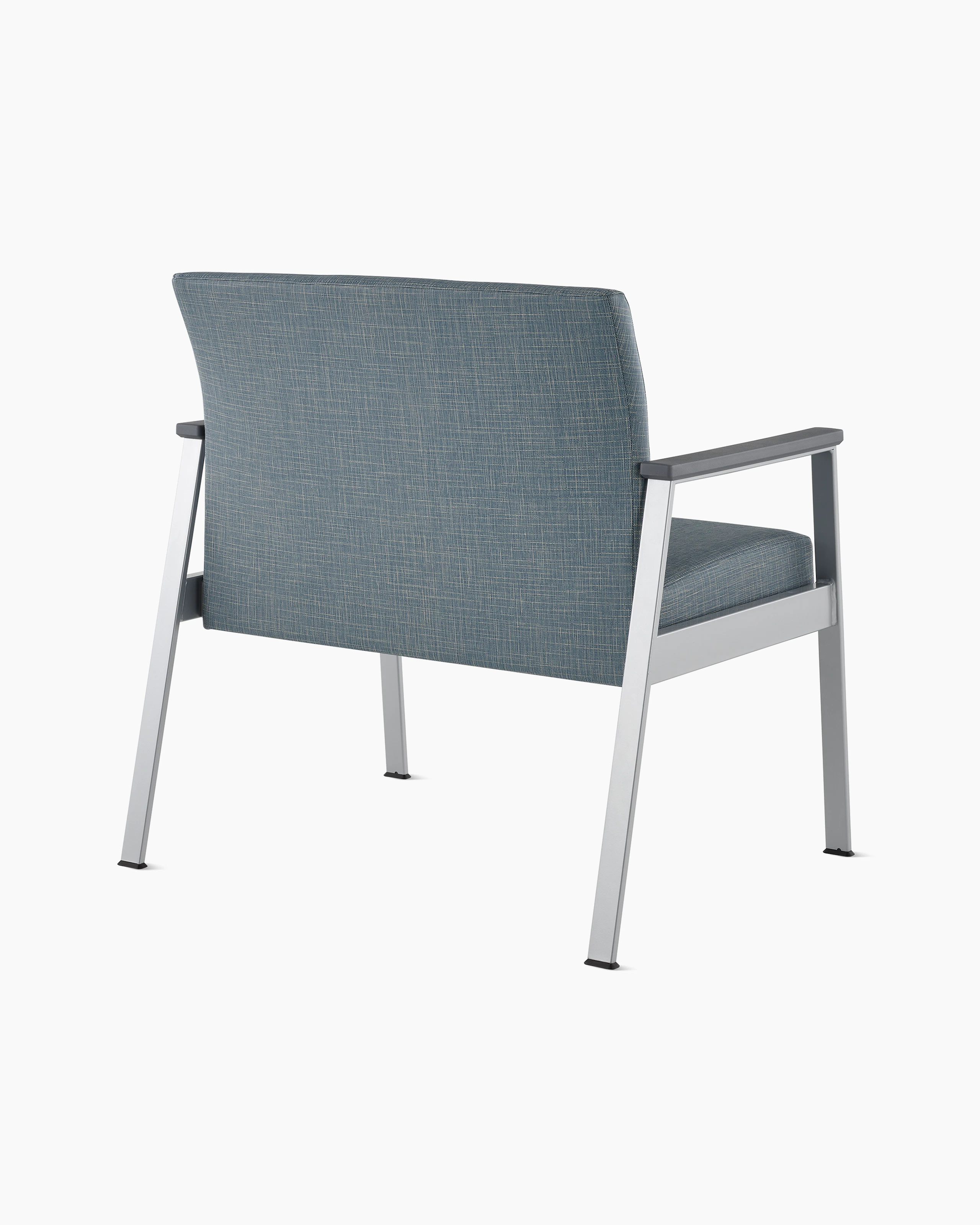Rear angle view of an Easton Plus Chair with blue upholstery, metallic four leg base and slate grey arm caps.