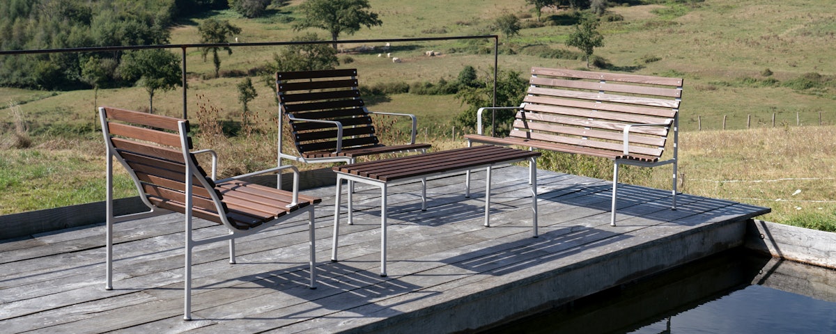 Two Traverse Lounge Chairs with a Traverse Bench at a poolside setting
