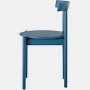 Profile view of a blue Comma Chair.