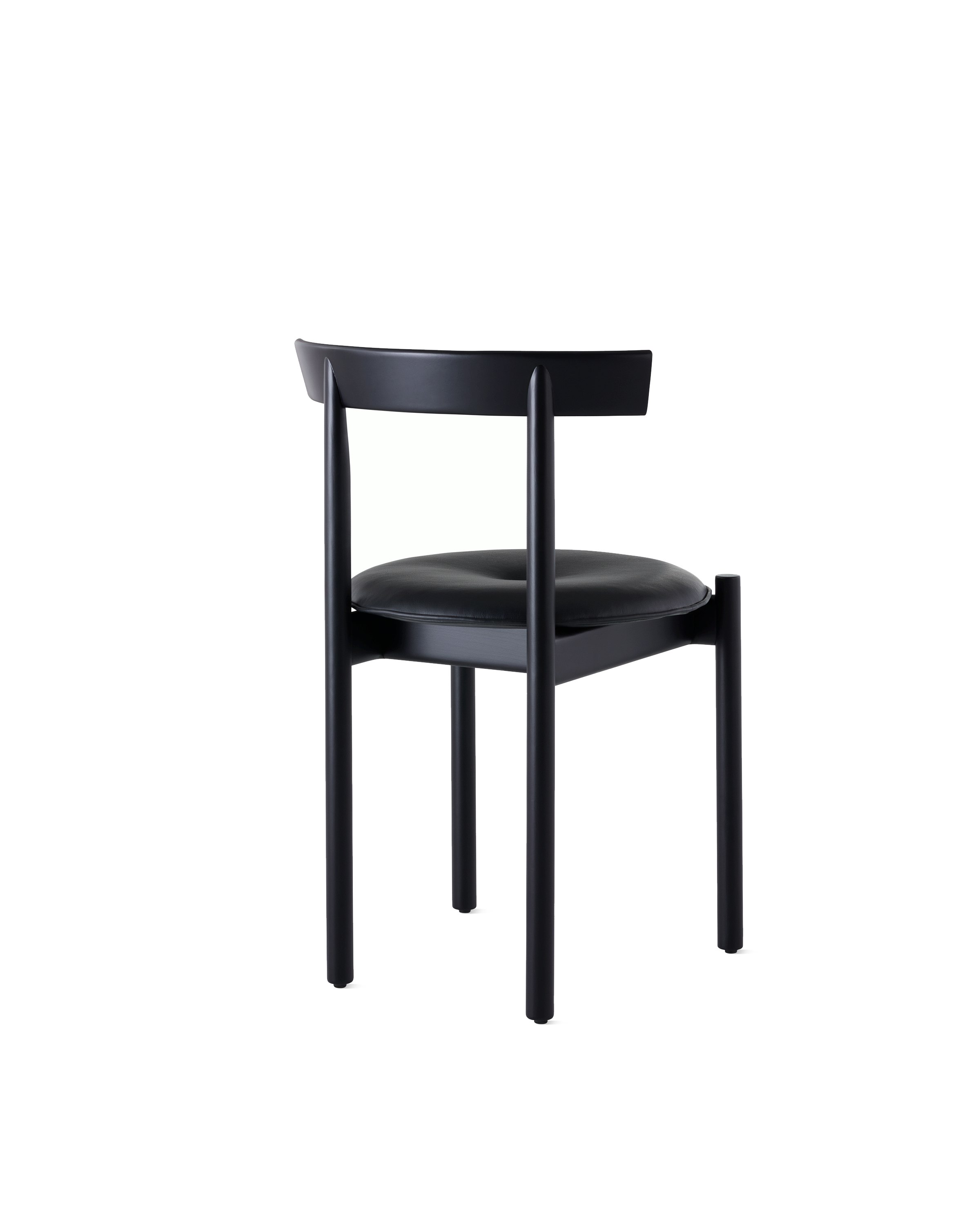 A black Comma Chair with a seat pad, viewed from the back at an angle.